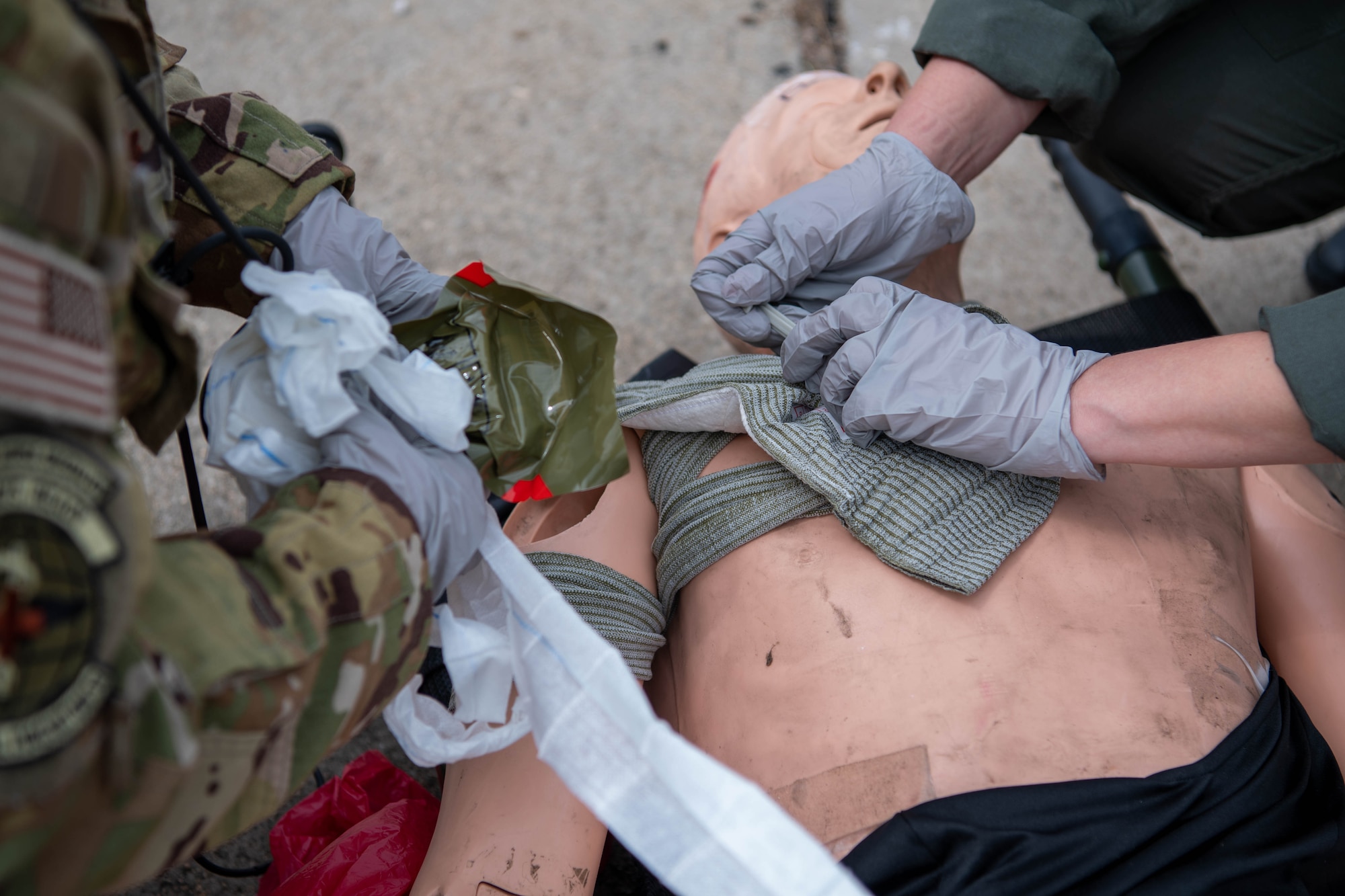 U.S. Air Force and Bulgarian air force aeromedical evacuation members work together to provide first aid in a simulated base attack during Thracian Summer 2023 at Cheshnegirovo Air Base, Bulgaria, Aug. 10, 2023.