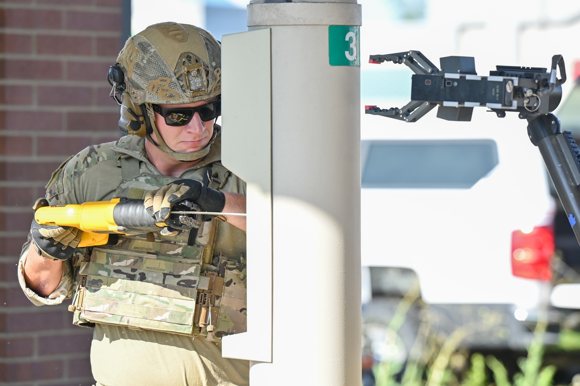 Staff Sgt. Tyler Simpkins, 775th Explosive Ordnance Disposal Flight, cuts into a bank pneumatic tube during the retrieval of a simulated explosive device at an off-base training event Aug. 10, 2023, in Roy, Utah.