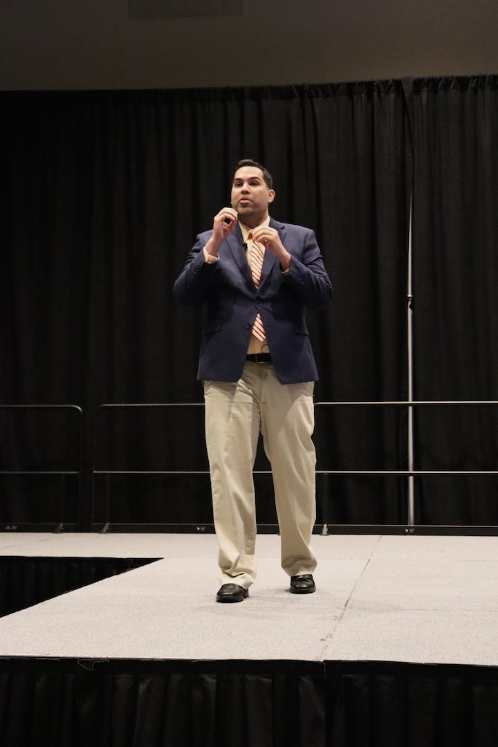 man on business suit on stage