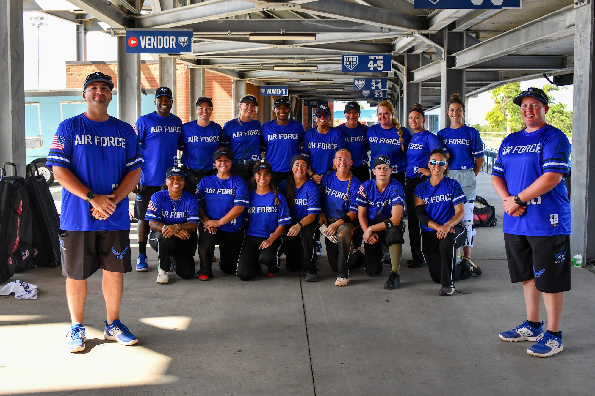 U.S. Air Force Capt. Pamela Quigney (right) and Master Sgt. Dylan King, Women's Air Force Softball Team coaches, take a photo with their team following an Armed Forces Sports softball tournament at the USA Softball Hall of Fame Complex in Oklahoma City, Aug. 8, 2023. Both coaches of the Air Force Women’s Softball Team hailed from the 97th Air Mobility Wing. (U.S. Air Force photo by Airman 1st Class Miyah Gray)