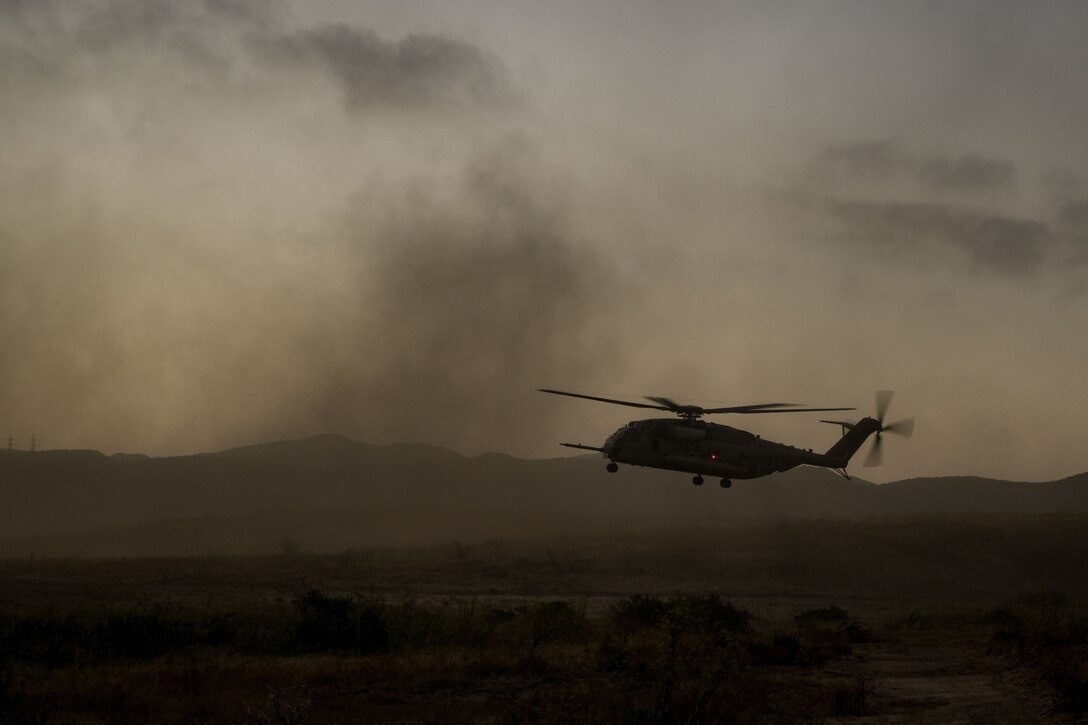 A CH-53E Super Stallion attached to Marine Medium Tiltrotor Squadron (VMM) 165 (Reinforced), 15th Marine Expeditionary Unit, prepares to land during a helicopter raid as part of an amphibious raid course at Marine Corps Base Camp Pendleton, California, Aug. 3, 2023. The raid course, conducted by Expeditionary Operations Training Group, I Marine Expeditionary Force, teaches and evaluates MEU forces’ capabilities to complete effective raids to seize an area to deny enemy actions and potentially provide information for future operations. (U.S. Marine Corps photo by Sgt. Smith)