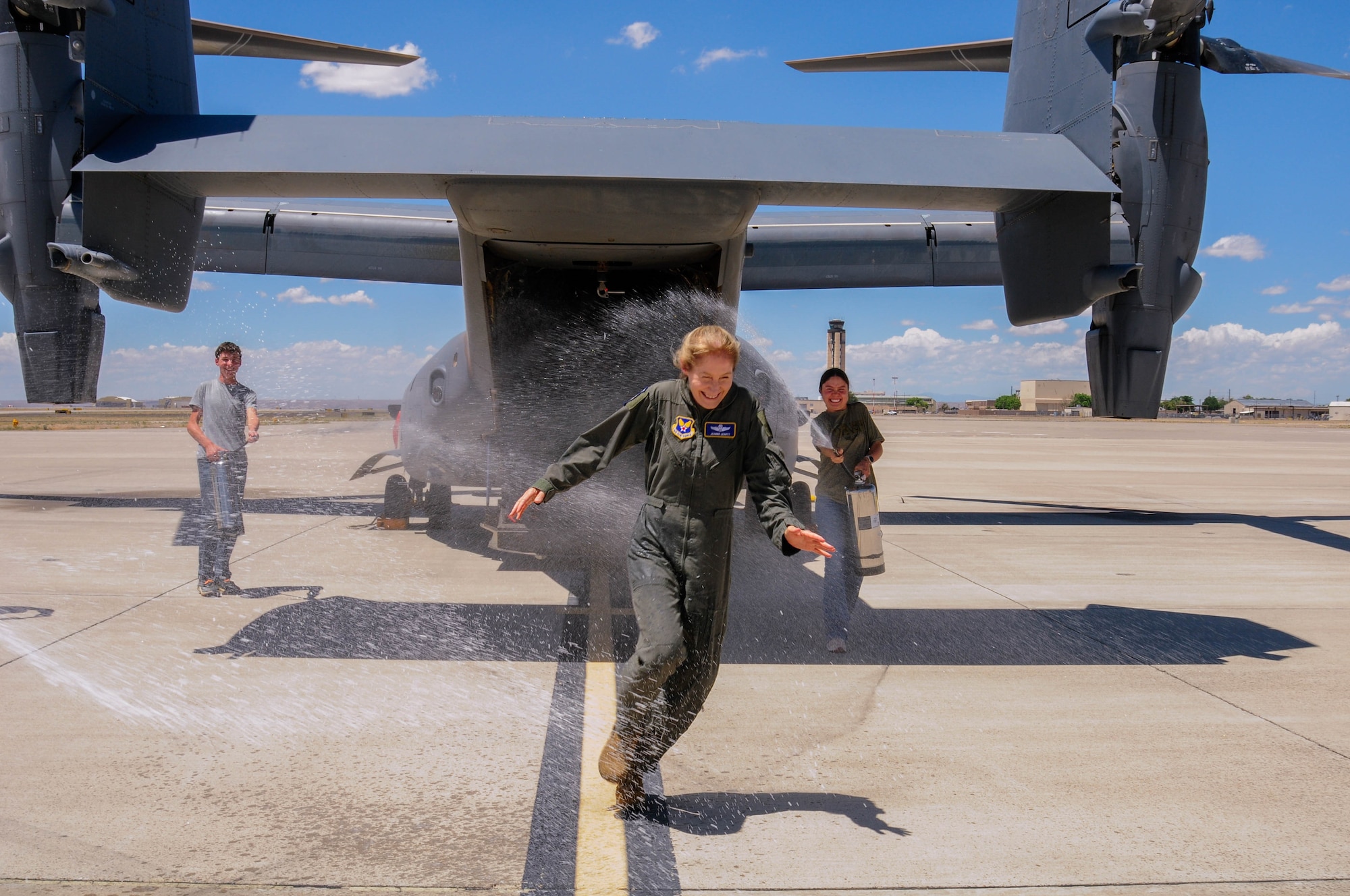 Maj. Gen. Jeannie M. Leavitt evades the water spray from her children