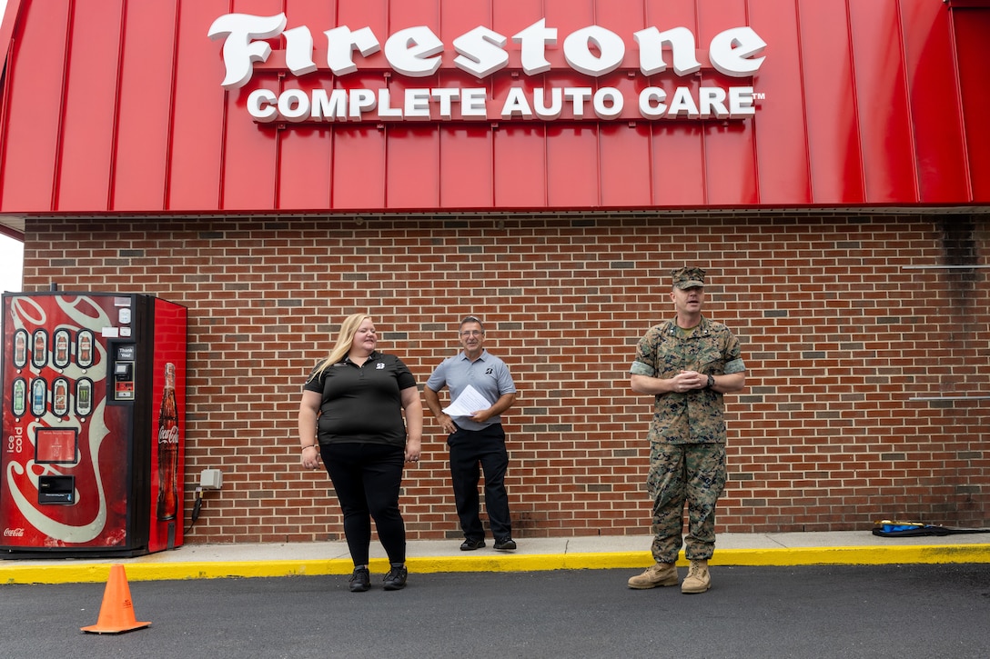 U.S. Marine Corps Lt. Col.  Kriket S. Holley executive officer Headquarters & Service Battalion, Fleet Marine Force, Atlantic, Marine Forces Command, Marine Forces Northern Command gives his remarks during the grand opening of the Camp Elmore Firsestone  Complete Auto Care at Naval Support Activity Hamptons Roads, August 10, 2023. The opening of Firestone Complete Auto Care will provide a needed car repair facility to serve civilians, military members and their families that live and work at near by military installations. (U.S. Marine Corps photo by SSgt. Servante R.Coba)