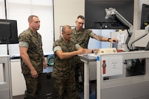 Norfolk, VA (August 4, 2023) U.S. Marines with Fleet Marine Force Atlantic, Marine Forces Command, Marine Forces Northern Command, review documents for the space, information operations, and electromagnetic spectrum working groups for Large Scale Exercise 2023 (LSE) at Naval Station Support Activity Hamptons Roads. LSE 2023 provides a venue to test and refine current and new technologies and platforms to reinforce our current position as a supreme maritime force and provide feedback used to inform future innovation. (U.S. Marine Corps photo by SSgt. Servante R. Coba)