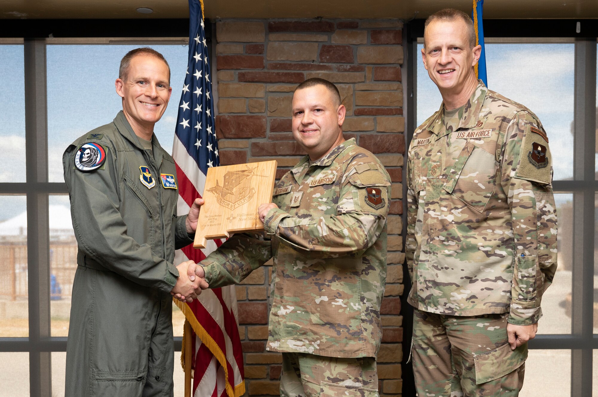 U.S. Air Force Tech. Sgt. Cyrus Bloxham, from the 49th Communications Squadron, accepts the 49th Wing Non Commissioned Officer of the Quarter Award, during the 49th Wing’s 2nd Quarter Award ceremony at Holloman Air Force Base, New Mexico, Aug. 11, 2023. Quarterly award winners were selected based on their technical expertise, demonstration of leadership and job performance. (U.S. Air Force photo by Airman 1st Class Michelle Ferrari)