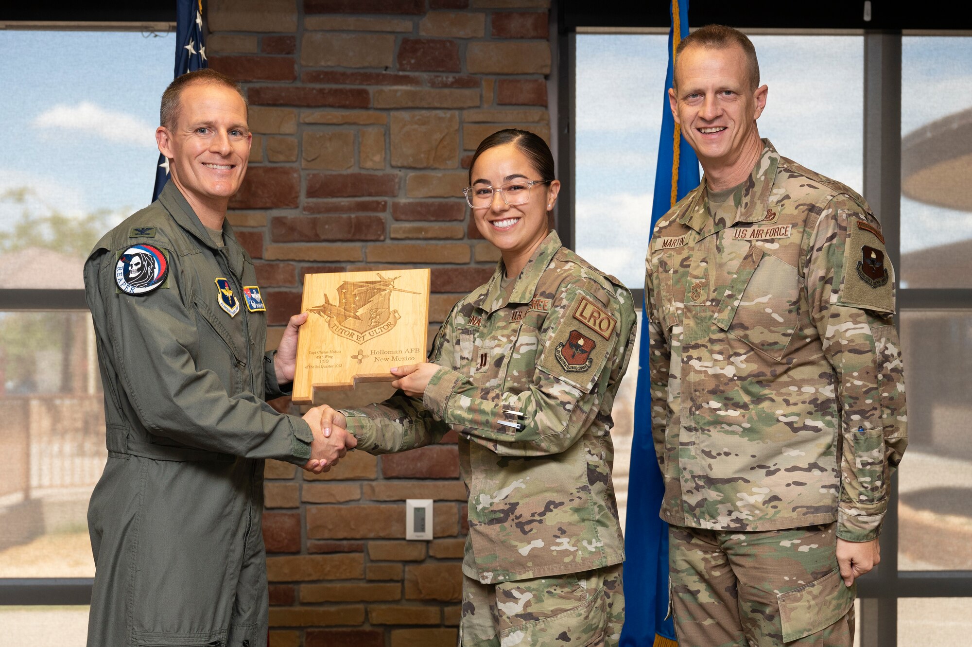 U.S. Air Force Capt. Cherae Medina, from the 49th Logistics Readiness Squadron, accepts the 49th Wing Company Grade Officer of the Quarter Award, during the 49th Wing’s 2nd Quarter Award ceremony at Holloman Air Force Base, New Mexico, Aug. 11, 2023. Quarterly award winners were selected based on their technical expertise, demonstration of leadership and job performance. (U.S. Air Force photo by Airman 1st Class Michelle Ferrari)