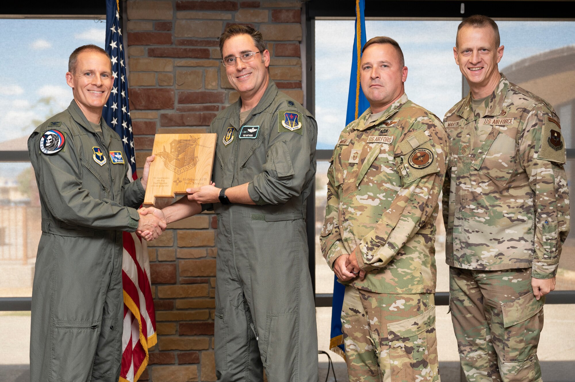 U.S. Air Force Lt. Col. Sean Matthews, left, and U.S. Air Force Senior Master Sgt. Kyle Smith, from the 29th Attack Squadron, accepts the 49th Wing’s Small Unit of the Quarter Award, during the 49th Wing’s 2nd Quarter Award ceremony at Holloman Air Force Base, New Mexico, Aug. 11, 2023. Quarterly award winners were selected based on their technical expertise, demonstration of leadership and job performance. (U.S. Air Force photo by Airman 1st Class Michelle Ferrari)