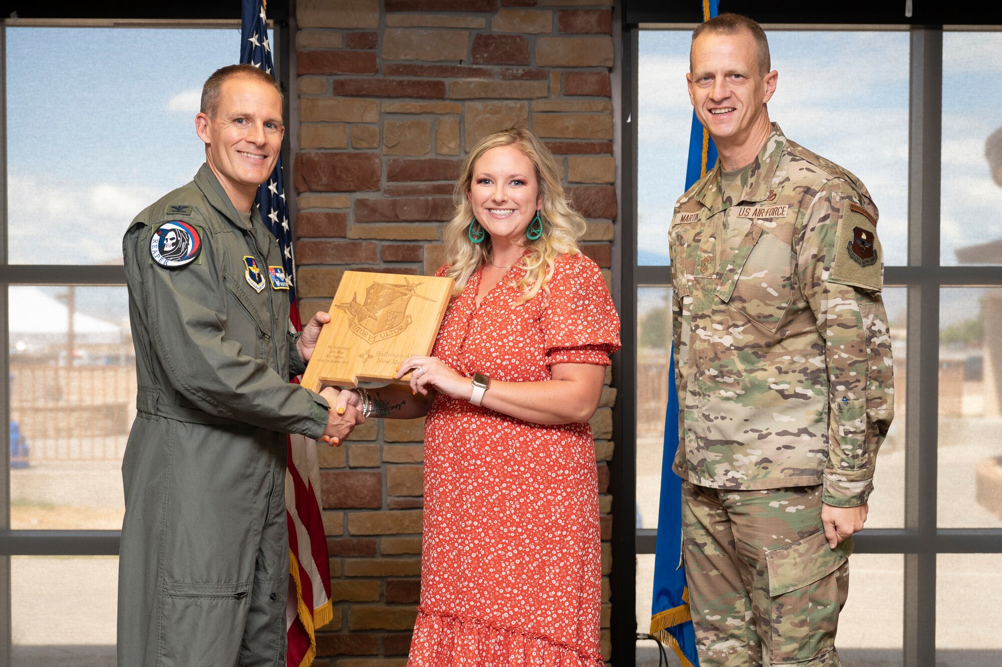 Mrs. Molly Muse, 29th Attack Squadron key spouse, accepts the 49th Wing Key Spouse of the Quarter Award, during the 49th Wing’s 2nd Quarter Award ceremony at Holloman Air Force Base, New Mexico, Aug. 11, 2023. Quarterly award winners were selected based on their technical expertise, demonstration of leadership and job performance. (U.S. Air Force photo by Airman 1st Class Michelle Ferrari)