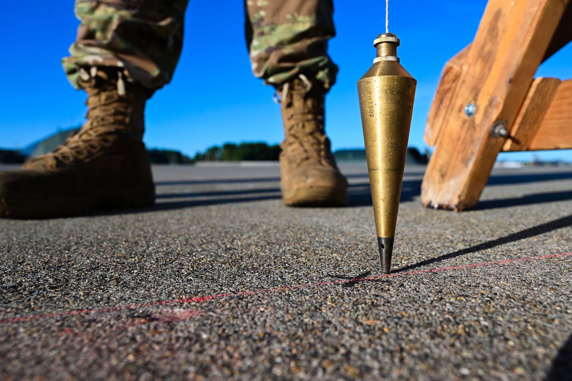 U.S. Air Force Staff Sgt. David Crowey, 87th Electronic Warfare Squadron Combat Shield avionics electronic warfare technician, utilizes a plumb bob for precision measurement to test the AN/ASQ-213 HARM Targeting Systems, at Misawa Air Base, Japan, Aug. 10, 2023. Combat Shield ensures U.S. Air Force air assets at Misawa AB have electronic warfare combat readiness and are effective to support a free and open Indo-Pacific. (U.S. Air Force photo by Staff Sgt. Ericka A. Woolever)