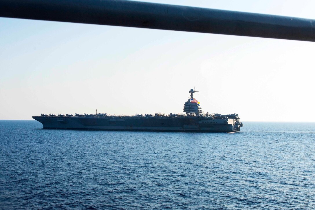 A ship travels through a body of water.