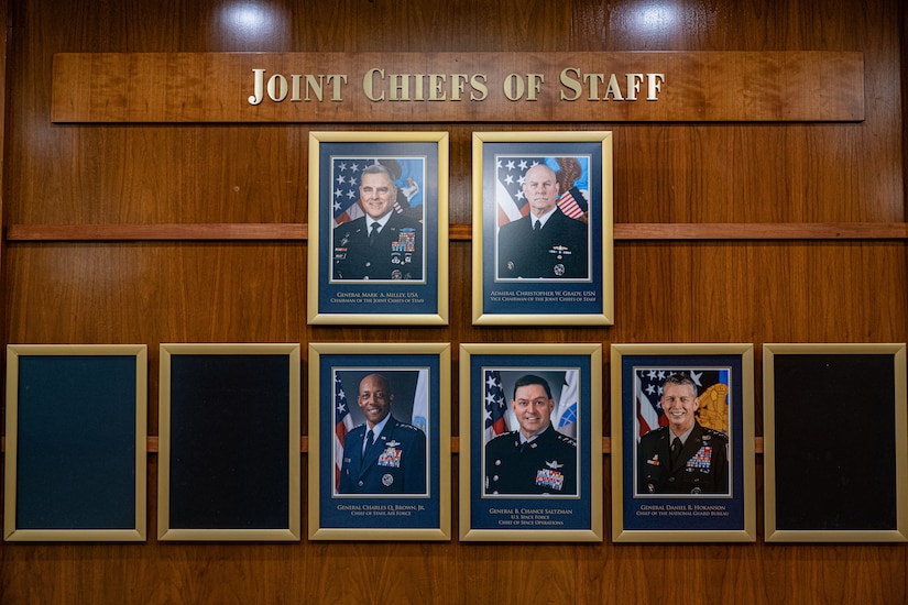 A group of eight picture frames, three of which are empty, hang below a sign that reads Joint Chiefs of Staff.