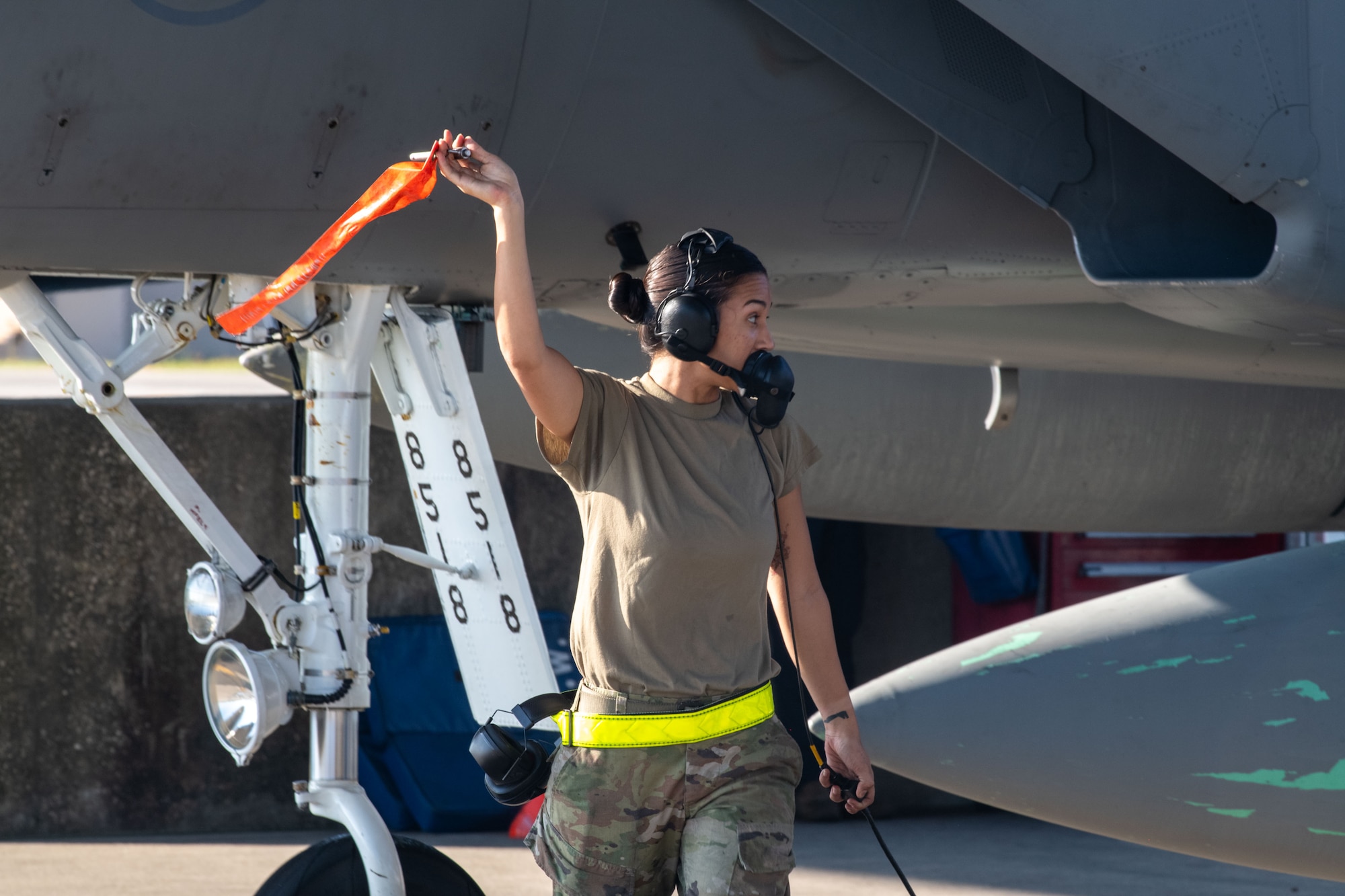 U.S. Air Force Senior Airman Avi Reed, crew chief, 125th Aircraft Maintenance Squadron, prepares an F-15C Eagle jet for takeoff at the Jacksonville Air National Guard Base, Florida, Aug. 14, 2023.  The aircraft was flown to the “boneyard” at Davis-Monthan Air Force Base in Tucson, Arizona, representing the wing’s divesture in the F-15C Eagle airframe. The installation will receive the first batch of F-35 Lightning II aircraft in early 2025. Conversion training for Airmen and infrastructure changes are currently underway to prepare for the change in mission, which will equip the wing with the Air Force’s most sophisticated fifth-generation fighter. The arrival of F-35s will posture 125th FW Airmen to meet air superiority and global strike needs for our nation’s defense, and mark the end of a 30-year era flying F-15 fighter jets. (U.S. Air Force photo by Tech Sgt. Chelsea Smith)