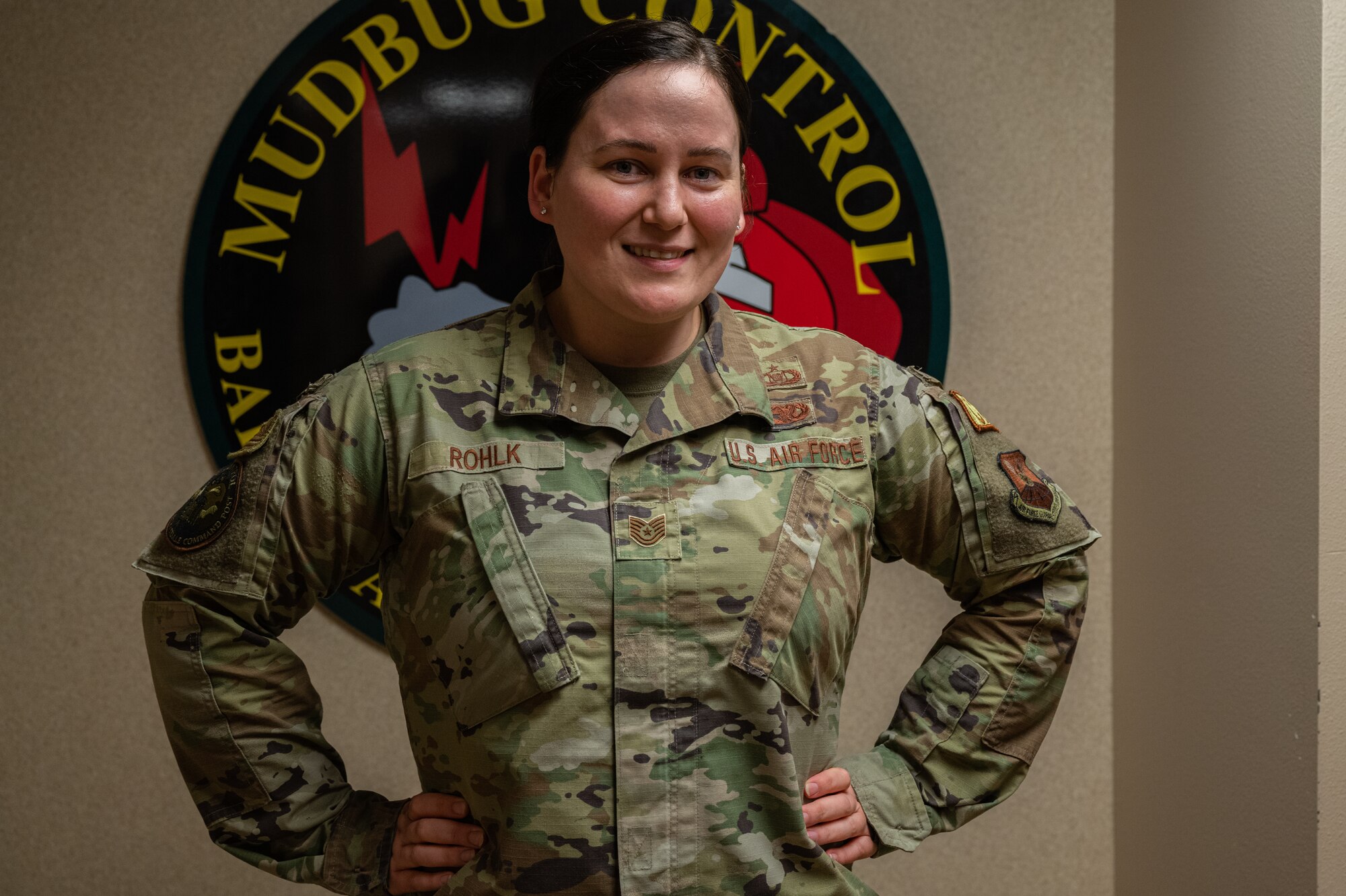 Tech Sgt. Sarah Rohlk, non commissioned officer in charge of nuclear command and control operation training at the Command Post, poses in front of CP patch.