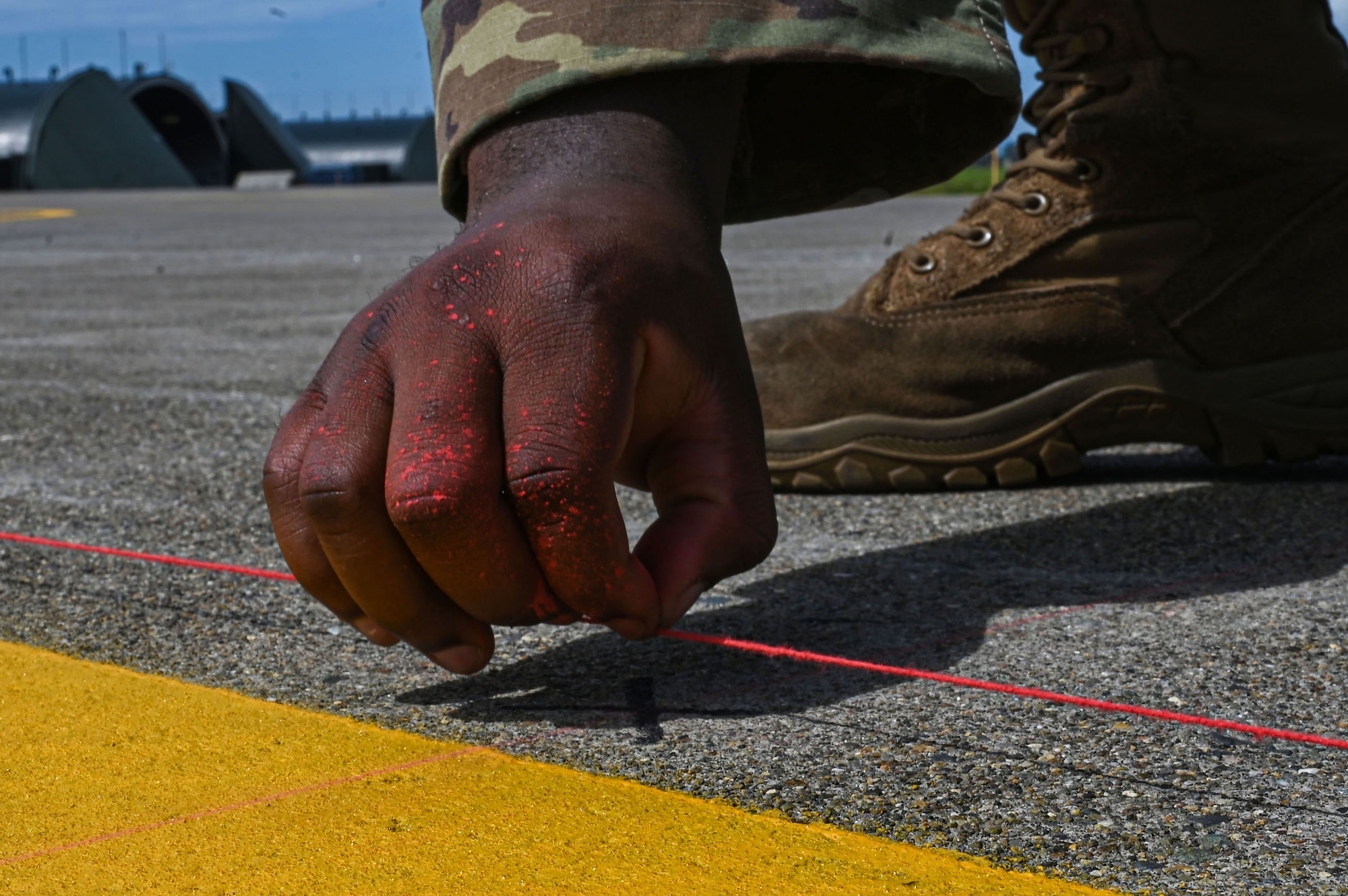 U.S. Air Force Staff Sgt. David Crowey, 87th Electronic Warfare Squadron Combat Shield avionics electronic warfare (EW) technician, pops a chalk line for measurement to test the AN/ASQ-213 HARM Targeting Systems, at Misawa Air Base, Japan, Aug. 9, 2023. Combat Shield ensured U.S. Air Force air assets at Misawa AB, Japan, have EW combat readiness and are effective to support a free and open Indo-Pacific. (U.S. Air Force photo by Staff Sgt. Ericka A. Woolever)