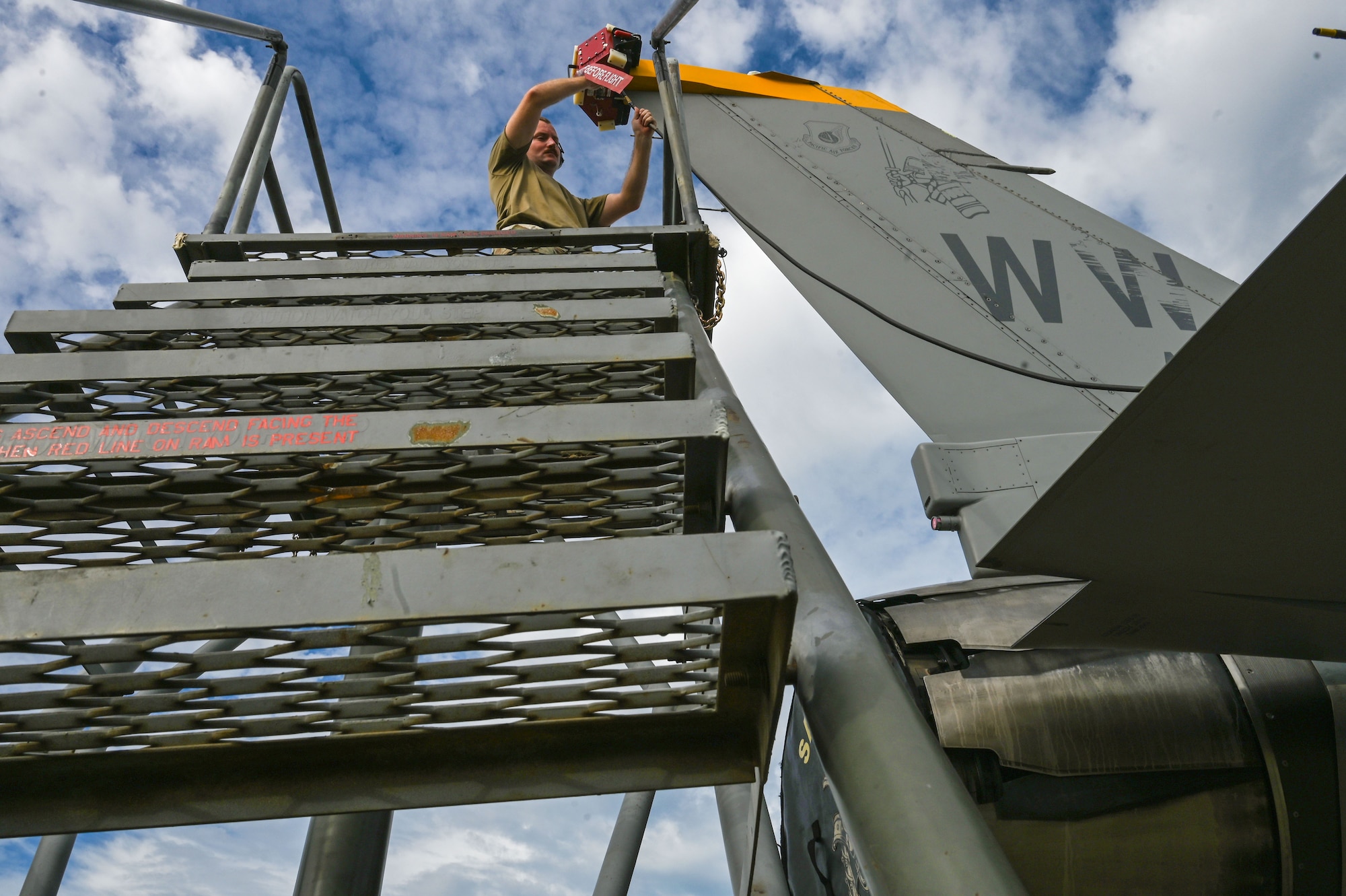 U.S. Air Force Tech. Sgt. Jacob Redding, 87th Electronic Warfare Squadron Combat Shield flight chief, from Nellis Air Force Base, Nev., installs the Radar Warning Receiver aft coupler on a U.S Air Force F-16 Fighting Falcon at Misawa Air Base, Japan, Aug. 9, 2023. Combat Shield is responsible for assessing the defensive system readiness of Combat Air Forces (CAF) aircraft by deploying assessment teams with specialized equipment to provide senior leadership an independent assessment of the overall health of CAF systems. (U.S. Air Force photo by Staff Sgt. Ericka A. Woolever)