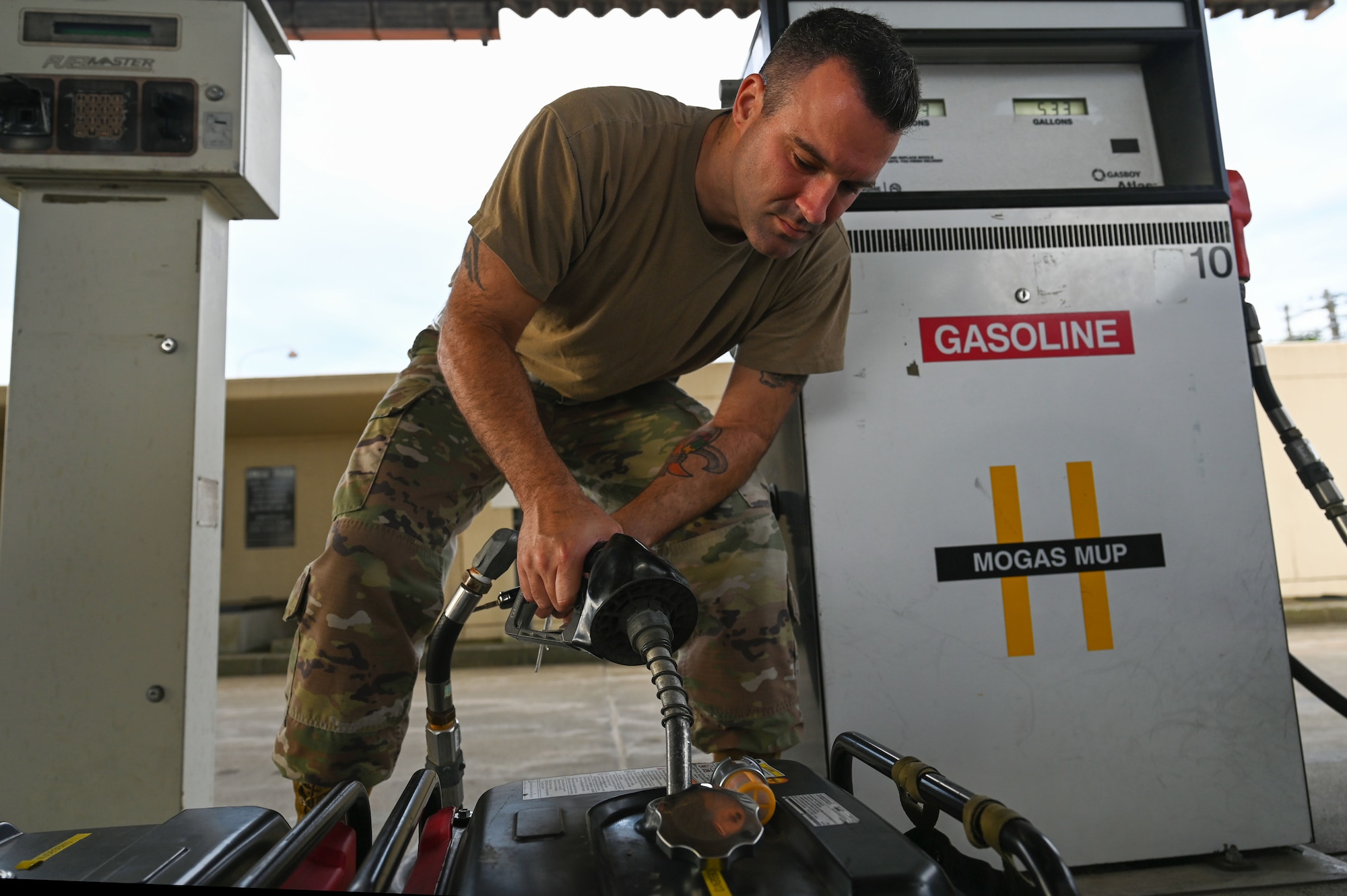U.S. Air Force Master Sgt. Jeremiah S. Johnson, 87th Electronic Warfare Squadron Combat Shield flight chief, fills two generators to power equipment to assess the electronic warfare (EW) defensive system readiness of U.S Air Force F-16 Fighting Falcons at Misawa Air Base, Japan, Aug. 9, 2023. Combat Shield ensures U.S. Air Force air assets at Misawa AB have EW combat readiness and are effective to support a free and open Indo-Pacific. (U.S. Air Force photo by Staff Sgt. Ericka A. Woolever)