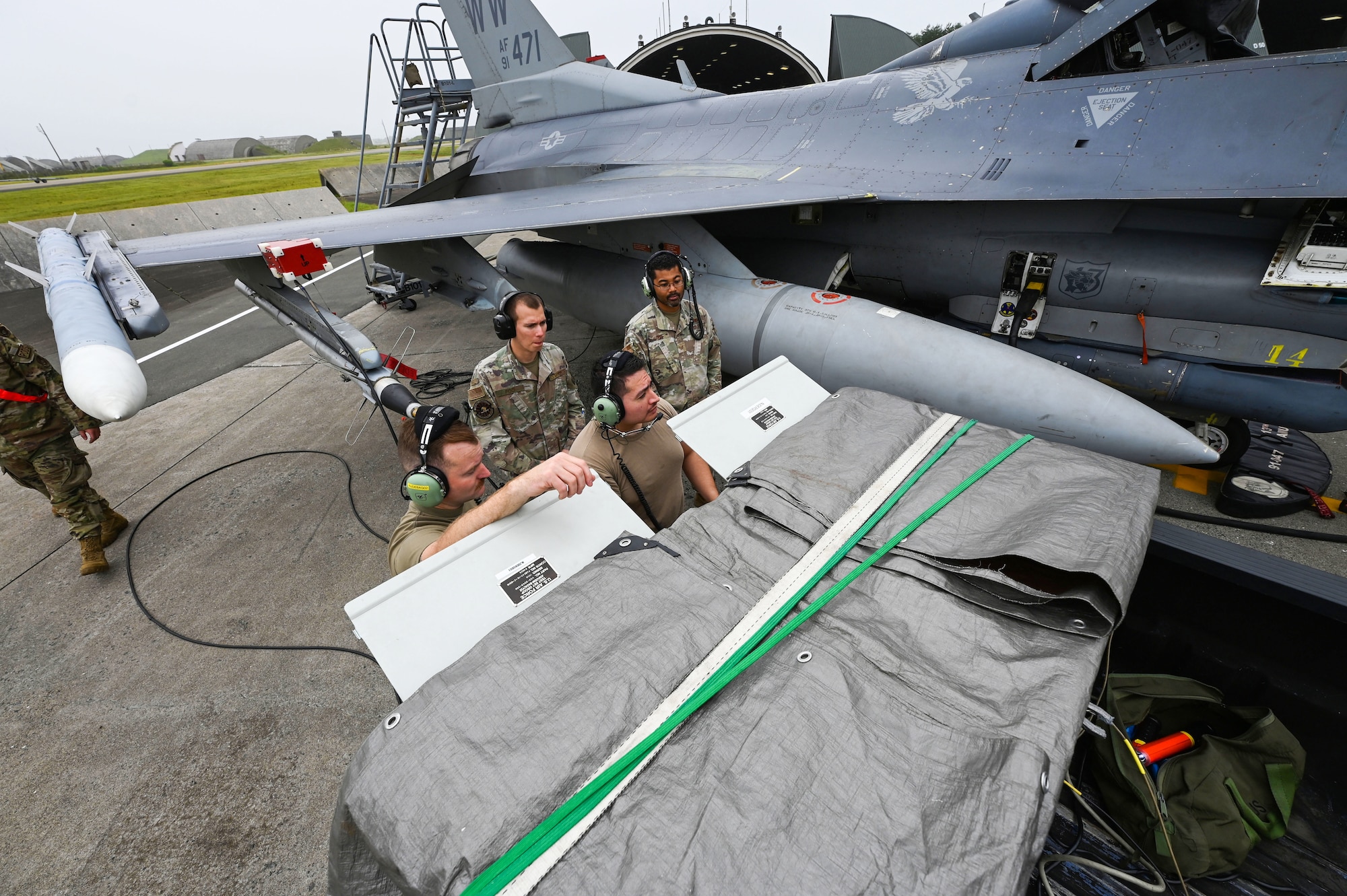 Airmen assigned to 87th Electronic Warfare Squadron Combat Shield assess the defensive system readiness of a U.S Air Force F-16 Fighting Falcon at Misawa Air Base, Japan, Aug. 8, 2023. Combat Shield is the lead U.S. Air Force air electronic warfare (EW) assessment program and is responsible for advising all MAJCOM-specific EW assessment programs. (U.S. Air Force photo by Staff Sgt. Ericka A. Woolever)