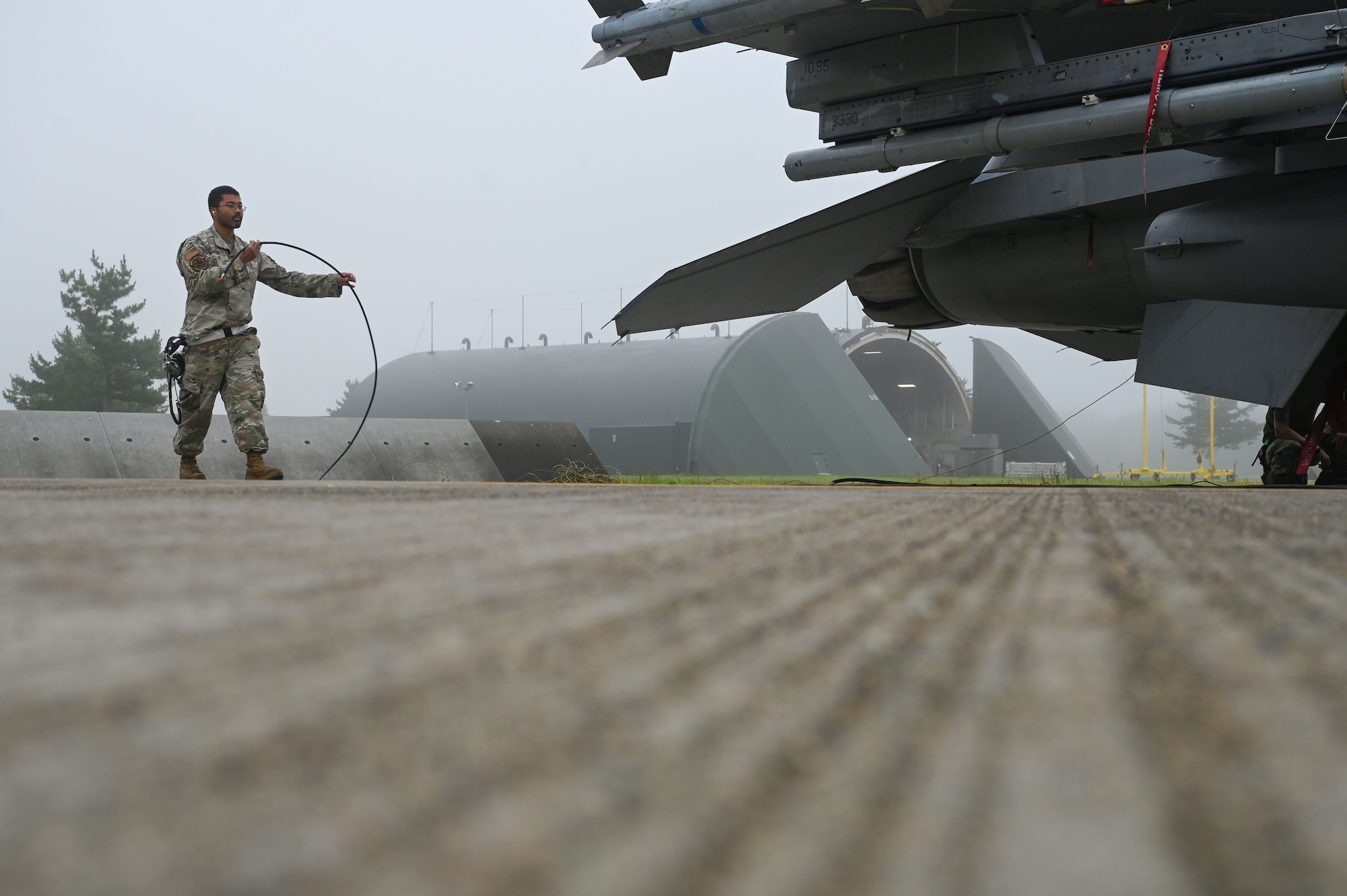 U.S. Air Force Tech. Sgt. Reginald Davis, 87th Electronic Warfare Squadron Combat Shield avionics electronic warfare (EW) technician, pulls out the radar frequency cable to assess the defensive system readiness of a U.S Air Force F-16 Fighting Falcon at Misawa Air Base, Japan, Aug. 8, 2023. Combat Shield ensures U.S. Air Force air assets at Misawa AB have EW combat readiness and are effective to support a free and open Indo-Pacific. (U.S. Air Force photo by Staff Sgt. Ericka A. Woolever)