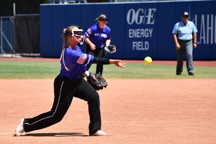 U.S. Air Force Staff Sgt. Kaila Backhaus, 31st Logistics Readiness Squadron supervisor of heavy-duty maintenance, pitches a softball during an Armed Forces Sports softball game at the USA Softball Hall of Fame Complex in Oklahoma City, Aug. 8, 2023. Events like these encourage service members to maintain their physical fitness. (U.S. Air Force photo by Airman 1st Class Miyah Gray)