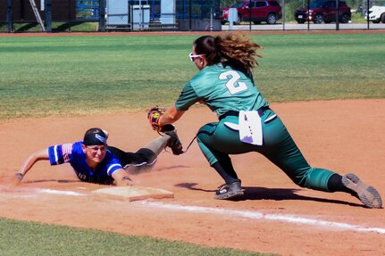 U.S. Marine Corps Sgt. Bailey Stiwinter, 2nd Combat Engineer Battalion engineer support company, tags U.S. Air Force Staff Sgt. Dana Vahey, 932nd Security Forces Squadron patrolman, as she slides to third base during an Armed Forces Sports softball game at the USA Softball Hall of Fame Complex in Oklahoma City, Aug. 8, 2023. The Department of the Air Force has more than 2,000 military athlete participants each year and compete against sister services during Armed Forces tournaments. (U.S. Air Force photo by Airman 1st Class Miyah Gray)