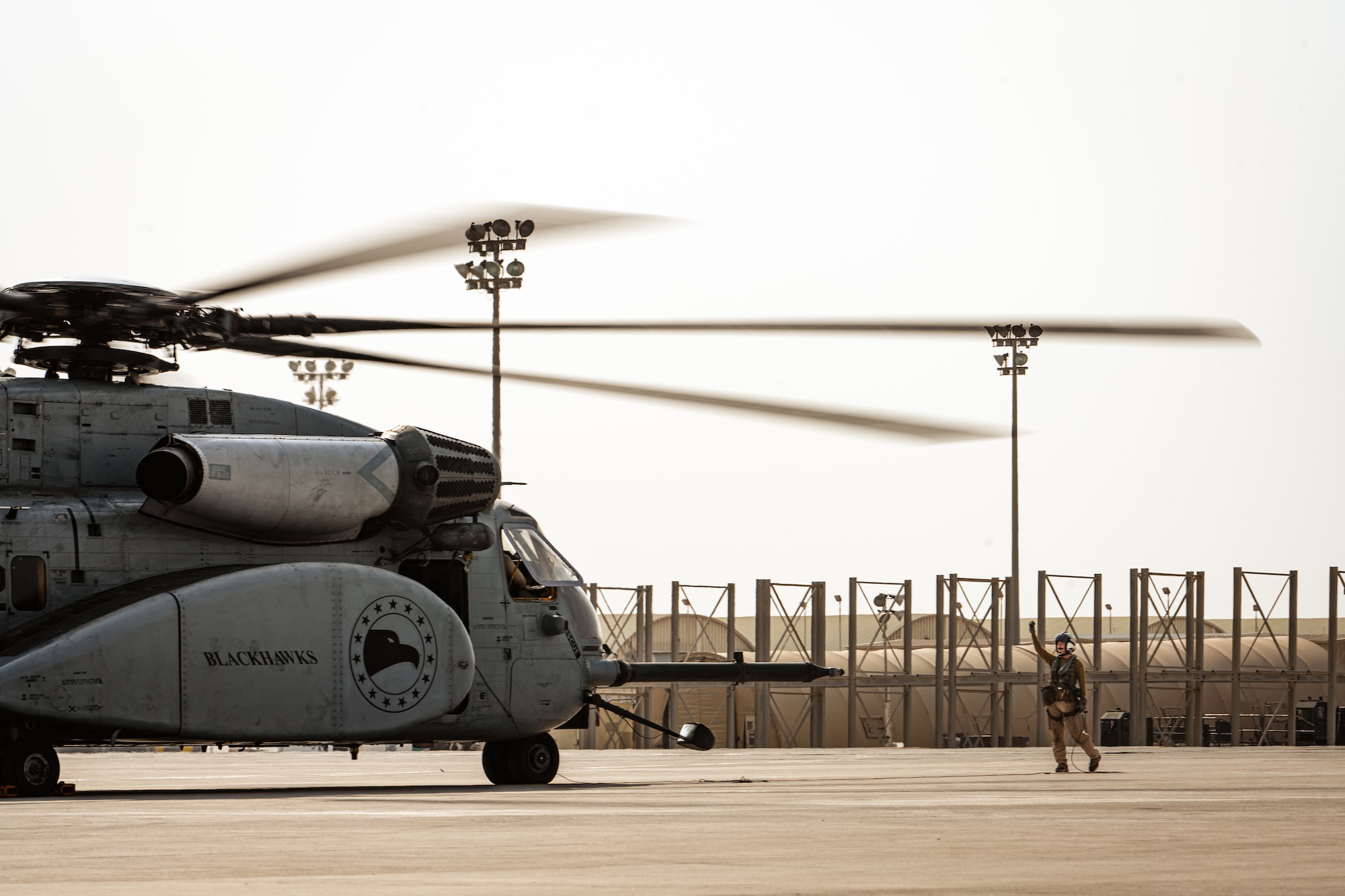 Photo of person marshaling a helicopter