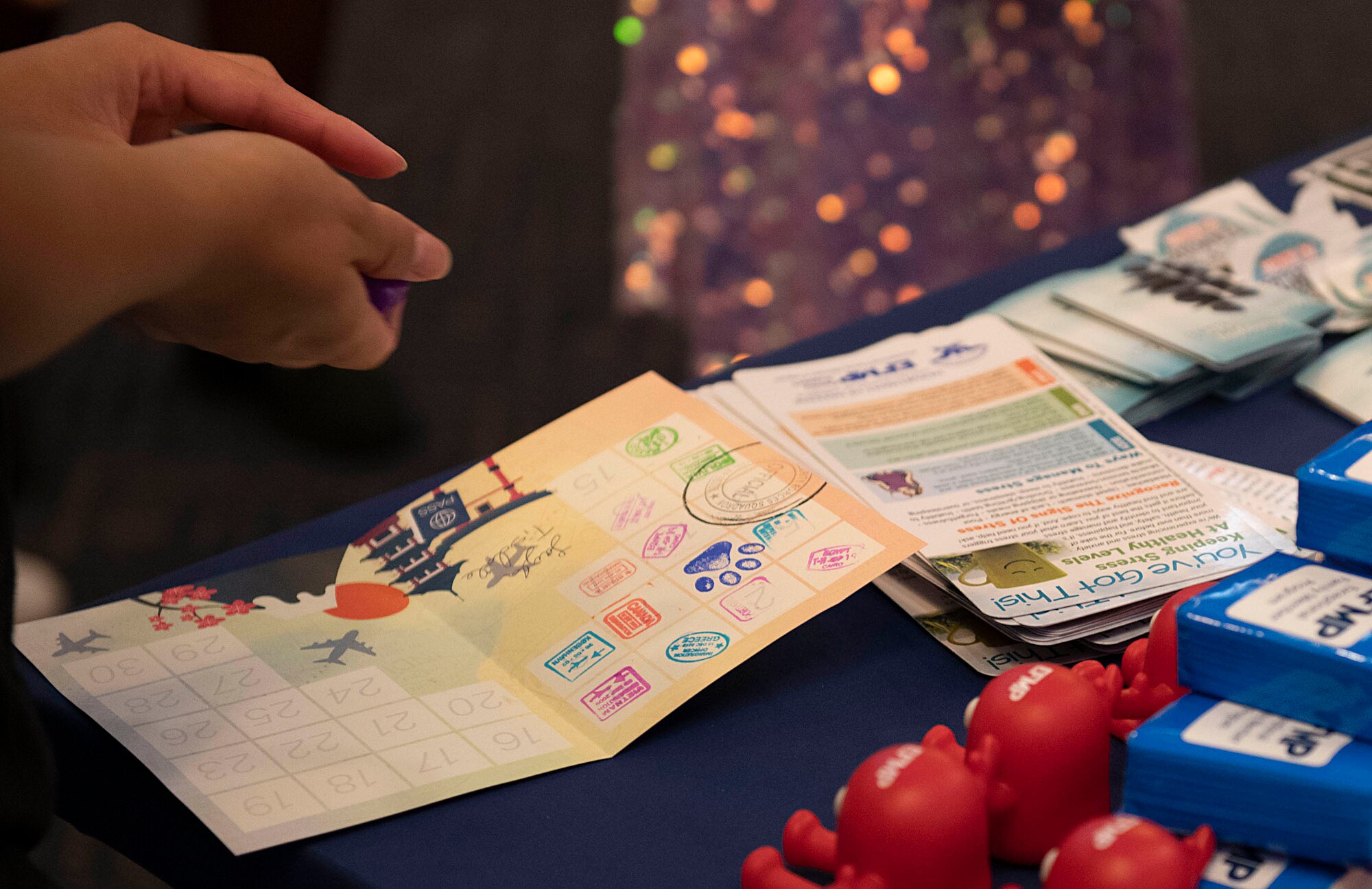 A booklet filled with stamps sits on a table.