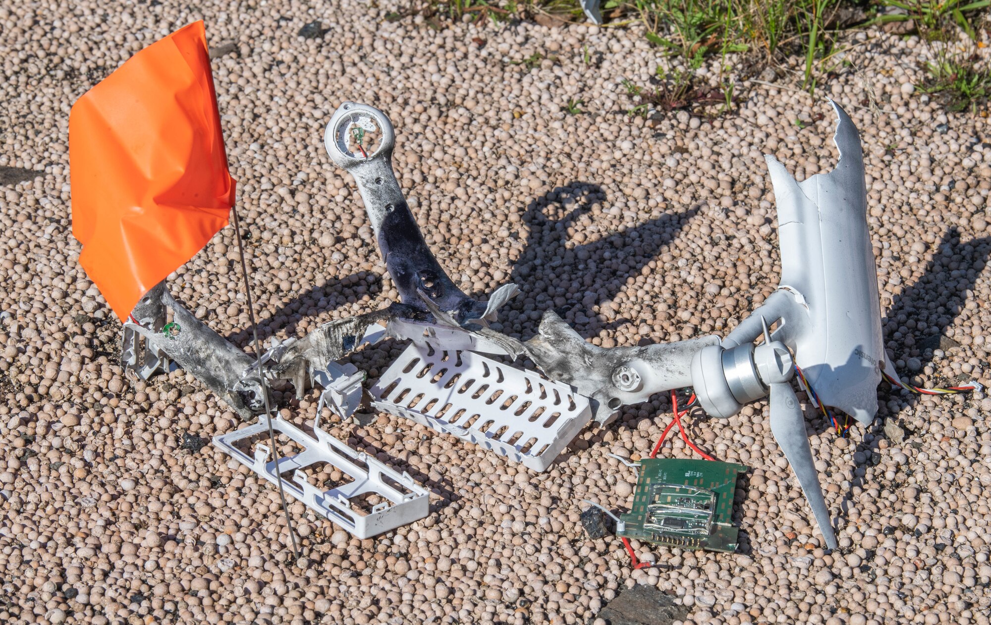 Evidence lies on the ground and is marked by an orange flag