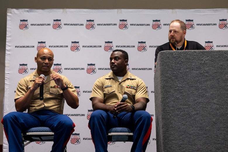 U.S. Marine Corps Capt. Terrence Zaleski, the marketing and communication officer for the 4th Marine Corps Recruiting District, and U.S. Marine Corps Capt. Wesley Williams, the officer selection officer for Recruiting Station Jacksonville, speaks to wrestling coaches about why wrestlers make great Marines during the National Wrestling Coaches Association Convention held in Ft. Lauderdale, Fla., on July 28, 2023. The partnership between NWCA and the Marine Corps aims to increase awareness of the Marine Corps among high school and college coaches, who are seen as key influencers in their communities, by engaging these influencers. The Marine Corps hopes to inspire more young people to consider a career in the Marine Corps and to promote the values of discipline, leadership and teamwork. (U.S. Marine Corps photo by Lance Cpl. Payton Goodrich)