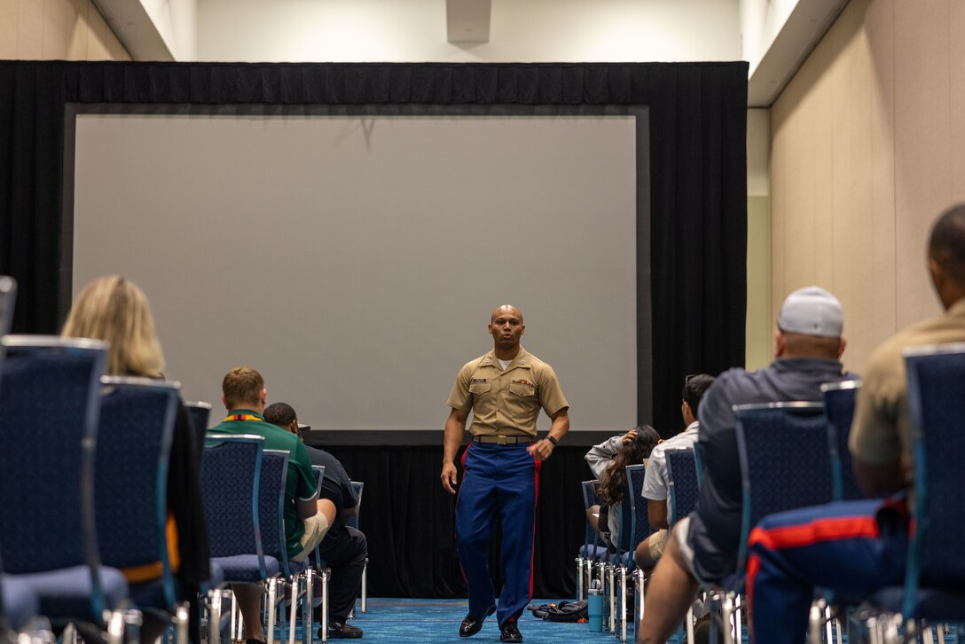 U.S. Marine Corps Capt. Terrence Zaleski, the marketing and communication officer for the 4th Marine Corps Recruiting District, and U.S. Marine Corps Capt. Wesley Williams, the officer selection officer for Recruiting Station Jacksonville, speaks to wrestling coaches about why wrestlers make great Marines during the National Wrestling Coaches Association Convention held in Ft. Lauderdale, Fla., on July 28, 2023. The partnership between NWCA and the Marine Corps aims to increase awareness of the Marine Corps among high school and college coaches, who are seen as key influencers in their communities, by engaging these influencers. The Marine Corps hopes to inspire more young people to consider a career in the Marine Corps and to promote the values of discipline, leadership and teamwork. (U.S. Marine Corps photo by Lance Cpl. Payton Goodrich)