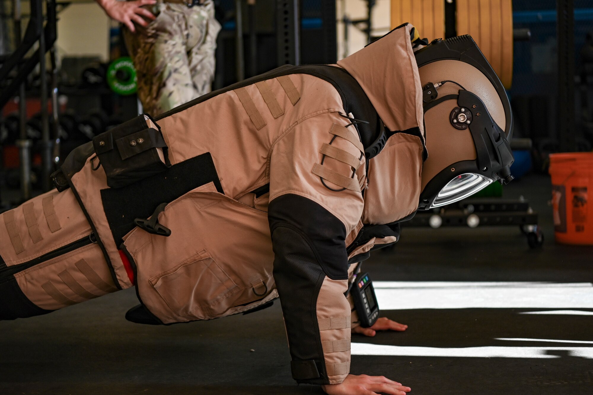 Wesley Teza, University of Florida Air Force ROTC cadet, does pushups in Explosive Ordnance Disposal individual protective equipment during an Air Force cadet tour at Dyess Air Force Base, Texas, July 18, 2023. The cadets toured 14 units around the base like security forces, logistics, medical, flightline operations and civil engineering. The tour gave the cadets the opportunity to get hands-on experience of life in the operational Air Force while seeing how Dyess impacts the overall Air Force mission. (U.S. Air Force photo by Airman 1st Emma Anderson)