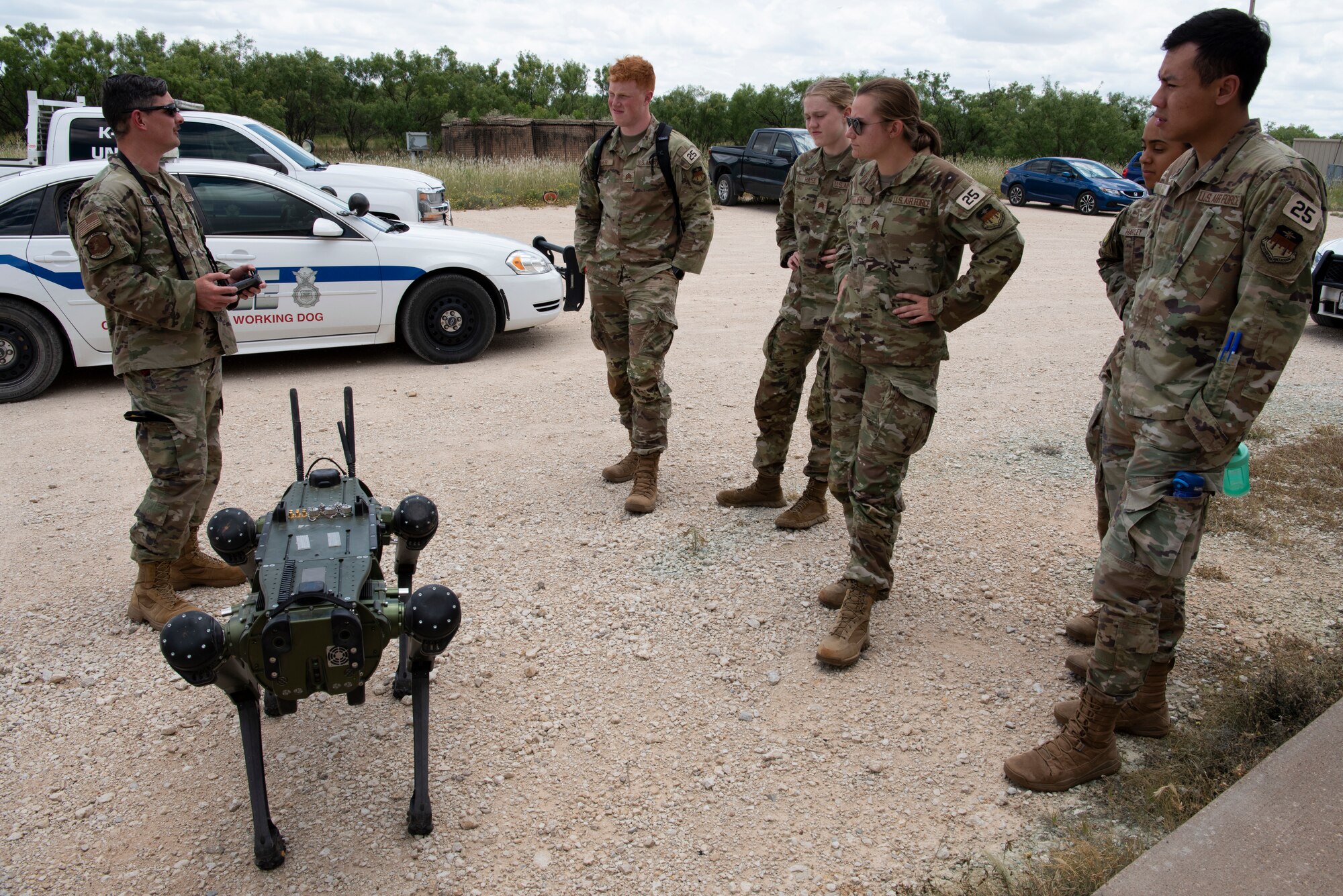 Airmen from the 7th Security Forces Squadron perform a robotic dog demonstration during an Air Force cadet tour at Dyess Air Force Base, Texas, June 30, 2023. Dyess hosted groups of Academy and Air Force ROTC cadets in a program that offered prospective officers the opportunity to learn about the base mission and career fields they may be interested in. The cadets toured 14 units around the base like security forces, logistics, medical, flightline operations and civil engineering. (U.S. Air Force photo by Airman 1st Class Alondra Cristobal Hernandez)