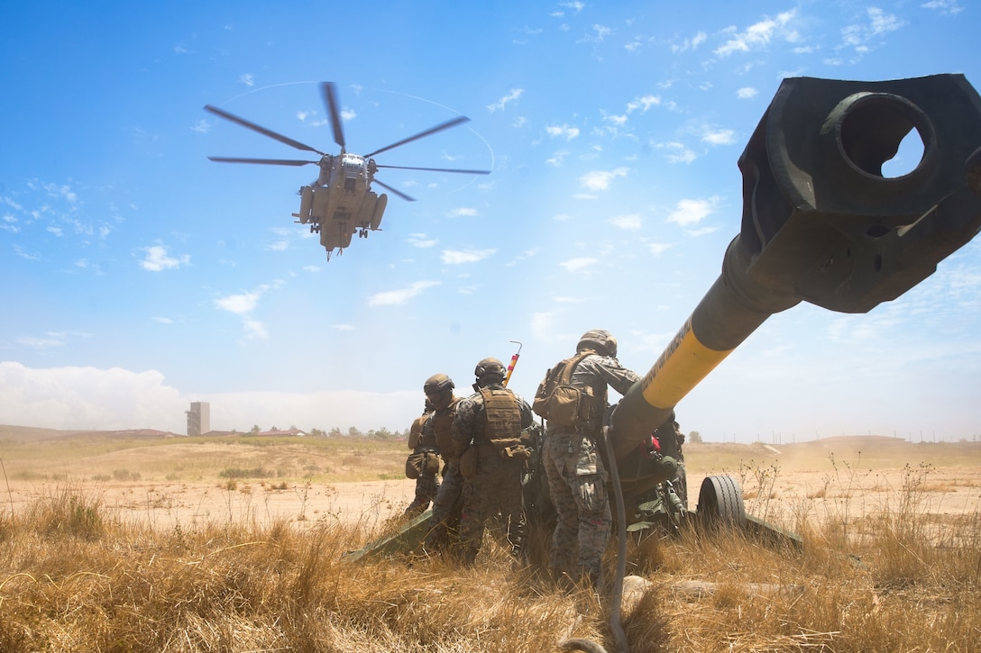 U.S. Marines assigned to Combat Logistics Battalion 15, 15th Marine Expeditionary Unit, observe as a CH-53E Super Stallion attached to Marine Medium tiltrotor Squadron (VMM) 165 (Reinforced), 15th MEU, lifts an M777 towed 155mm howitzer during a helicopter support team training at Marine Corps Base Camp Pendleton, California, Aug. 3, 2023. HSTs are responsible for the rapid transportation of cargo via helicopter for ship-to-shore movements, or movement to expeditionary sites when ground transportation is not feasible. (U.S. Marine Corps photo by Lance Cpl.  Kahle)