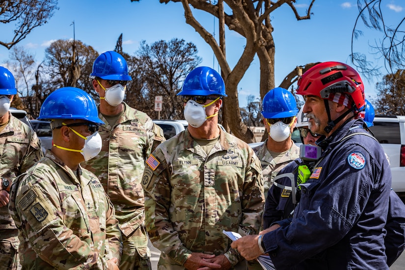 Soldiers speak with local search, rescue and recovery personnel after wildfires in Maui, Hawaii.