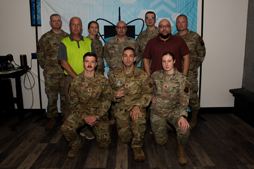 Members of Atomic Spark pose with their 2022 General Spencer Innovation Award at Minot Air Force Base, North Dakota, Aug. 14, 2023. Created out of the merger of the 5th Bomb Wing’s innovation cell BUFFWERX and the 91st Missile Wing’s innovation cell BULLYWERX, Atomic Spark is the first joint wing physical innovation cell in all of Air Force Global Strike Command.