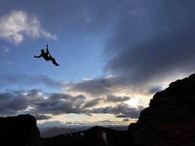 Alaska Air National Guard Tech. Sgt. Michael Rogers, 212th Rescue Squadron pararescueman, hoists from a 210th Rescue Squadron HH-60G Pave Hawk helicopter Aug. 11, 2023, near Tonsina, Alaska. Rogers helped rescue two sheep hunters stranded on a cliff.