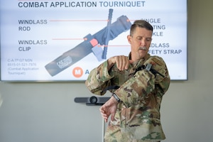 U.S. Air Force Staff Sgt. Layman Franklin, 709th Cyberspace Squadron support center noncommissioned officer in charge, demonstrates how to put on a tourniquet at Patrick Space Force Base, Florida, Aug. 15, 2023. Franklin is a Tactical Combat Casualty Care and Stop the Bleed instructor for Airman, Guardians, and civilians around the base. (U.S. Space Force photo by Senior Airman Dakota Raub)