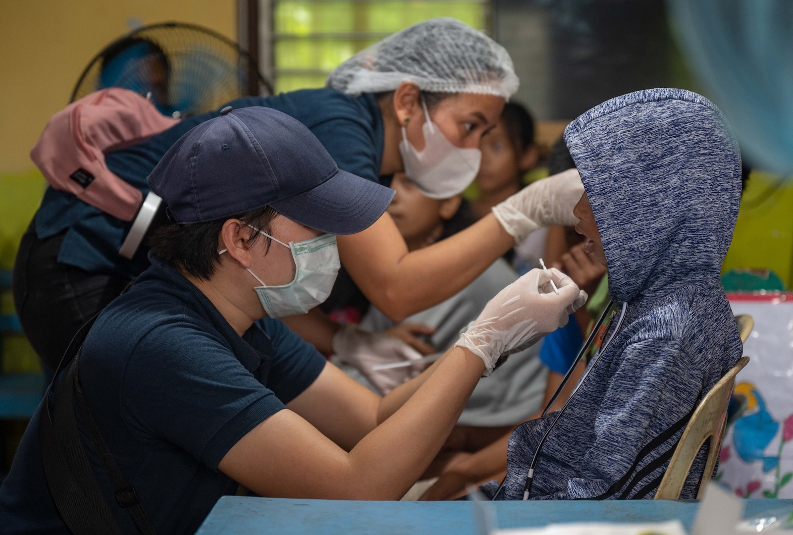 Medical professionals from the Palawan Dental Chapter apply fluoride and provide oral care for local children during a medical civic action program hosted by members of a U.S. Naval Special Warfare unit and U.S. Civil Affairs in Palawan, Philippines, July 29, 2023. Naval Special Warfare is the nation’s elite maritime special operations force, uniquely positioned to extend the Fleet’s reach and gain and maintain access for the Joint Force in competition and conflict. (U.S. Navy Photo by Mass Communication Specialist 1st Class Daniel Gaither)