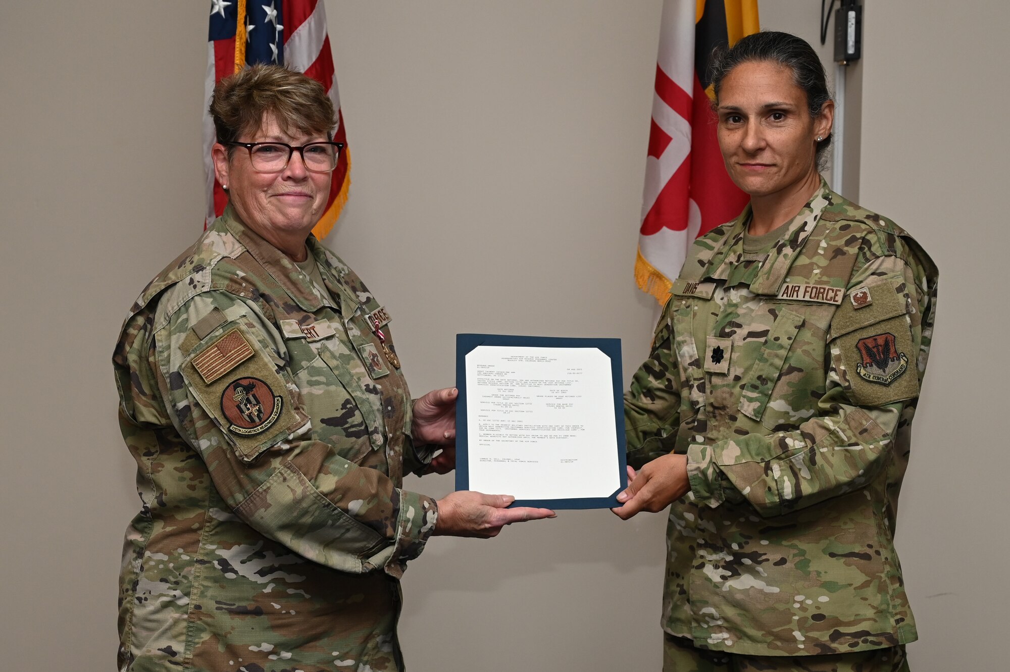U.S Air Force Senior Master Sgt. Jacqueline A. Talbert, avionics superintendent of the 175th Maintenance Squadron, receives a retirement order from U.S. Air Force Lt. Col. Aliysa Davis, Maryland National Guard Joint Force Headquarters A5/7 director, at Martin State Air National Guard Base, Middle River, Maryland, on Aug. 12, 2023.