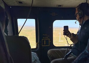 person taking photos from a helicopter with his phone