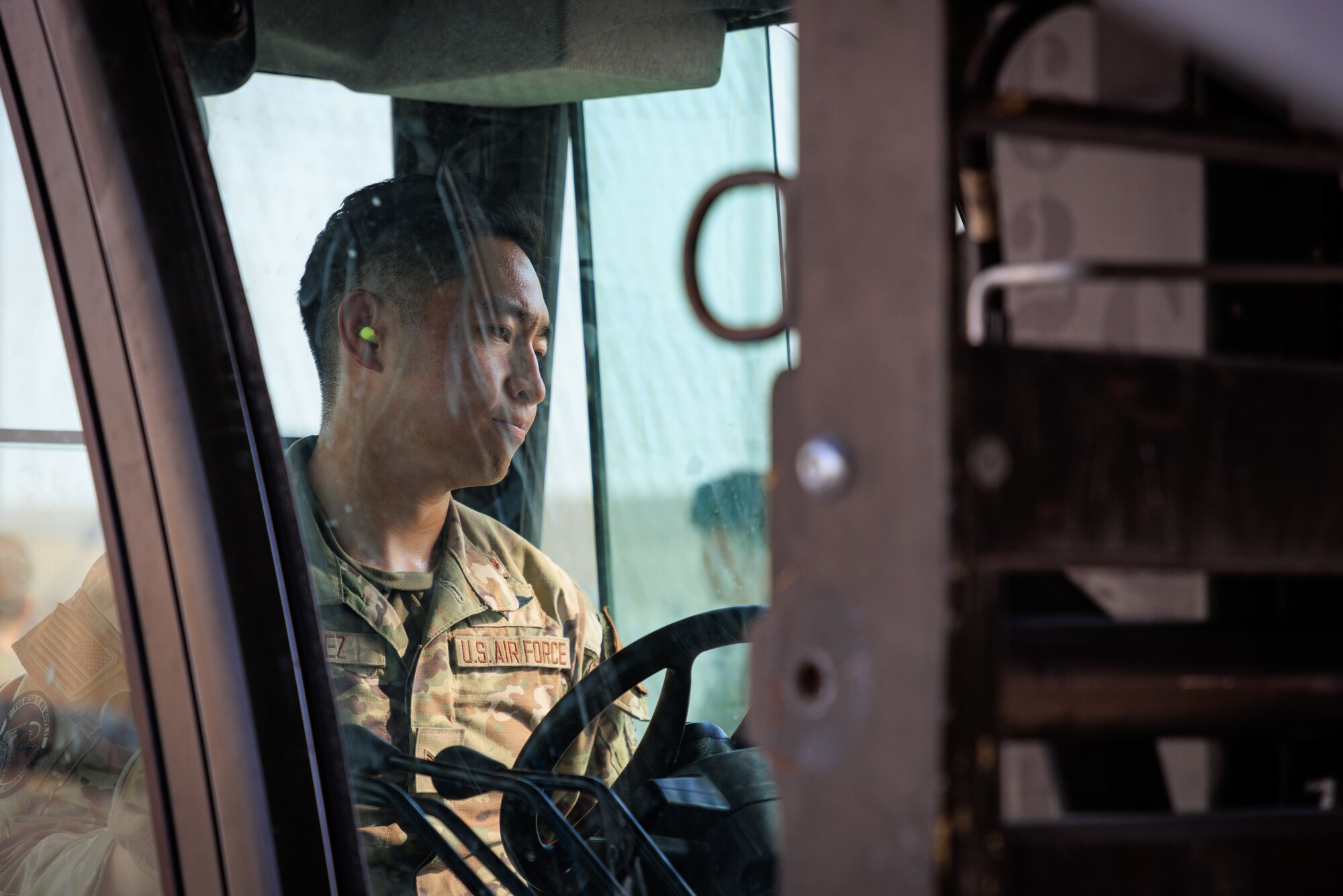 Photo of person operating a forklift on a flight line