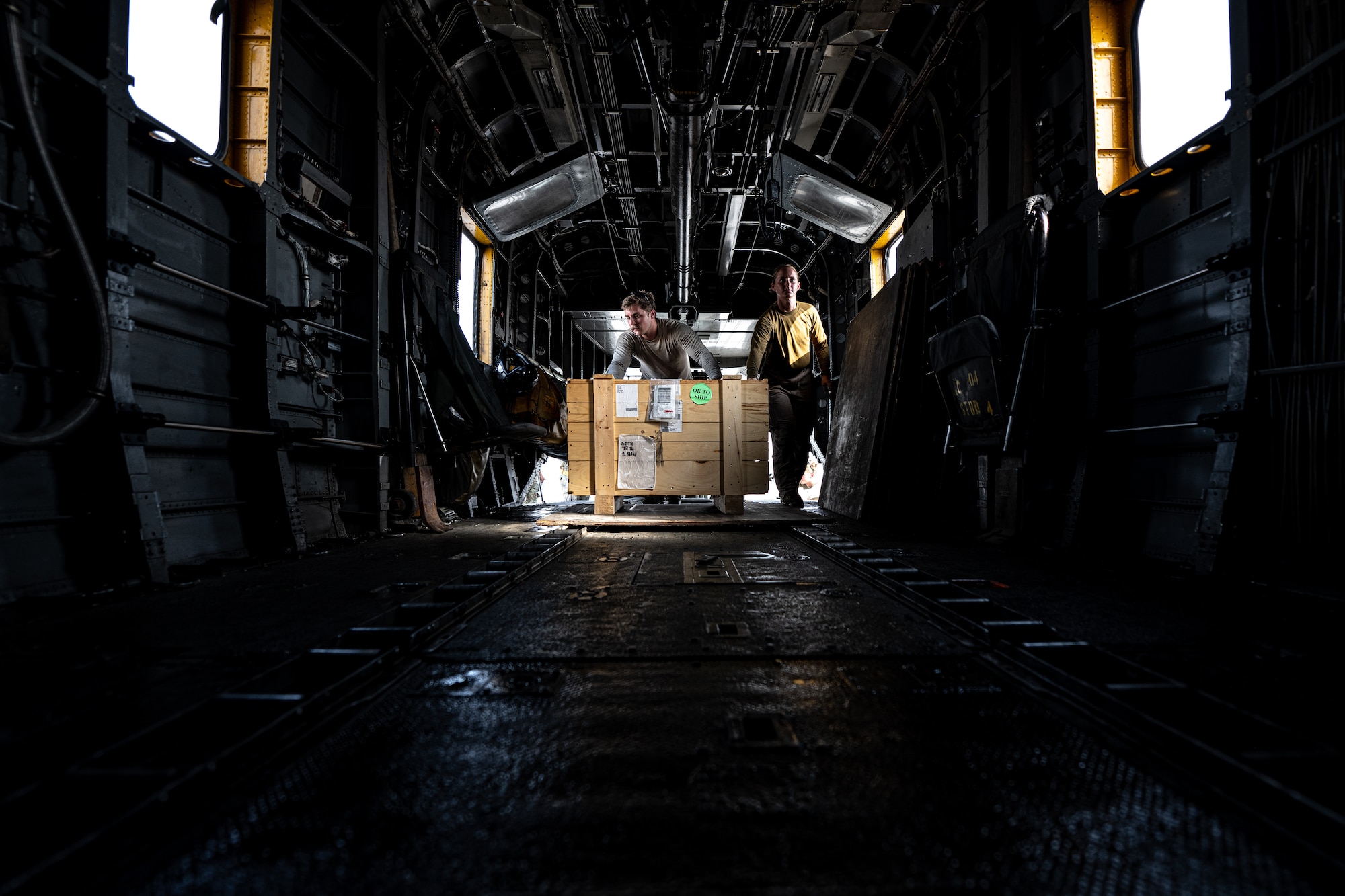 Photo of person loading cargo onto an aircraft