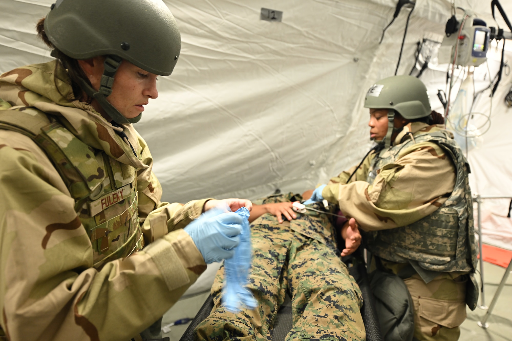 Master Sgt. Julie Fuleky, a medical technician assigned to the 433rd Medical Group at Joint Base San Antonio-Lackland, Texas, and Capt. Ranieka Lee, a clinical nurse also assigned to the 433MDG, provide care for a patient during Exercise Patriot Medic at Youngstown Air Reserve Station, Ohio, Aug. 16, 2023.