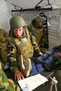 Maj. Kathryn Camplen, a member of the 433rd Medical Group at Joint Base San Antonio-Lackland, Texas, reviews patient information while providing emergency care at Youngstown Air Reserve Station, Ohio, Aug. 16, 2023.