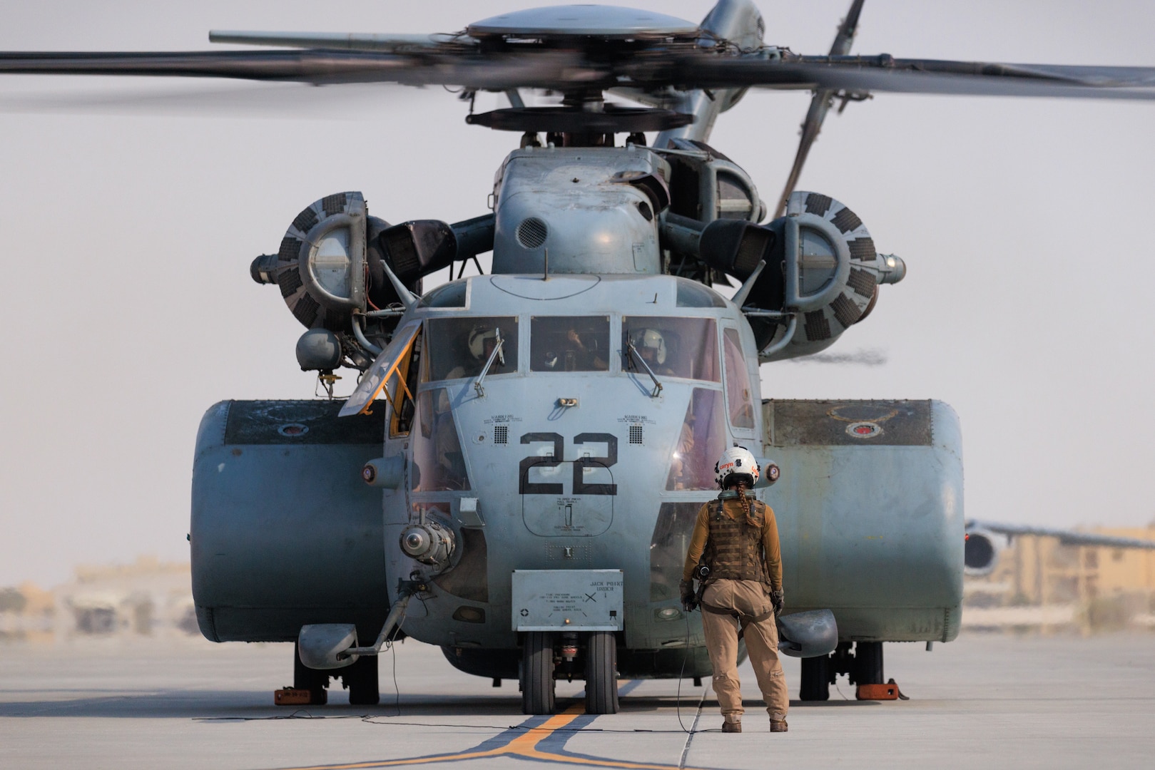 Photo of person marshaling a helicopter