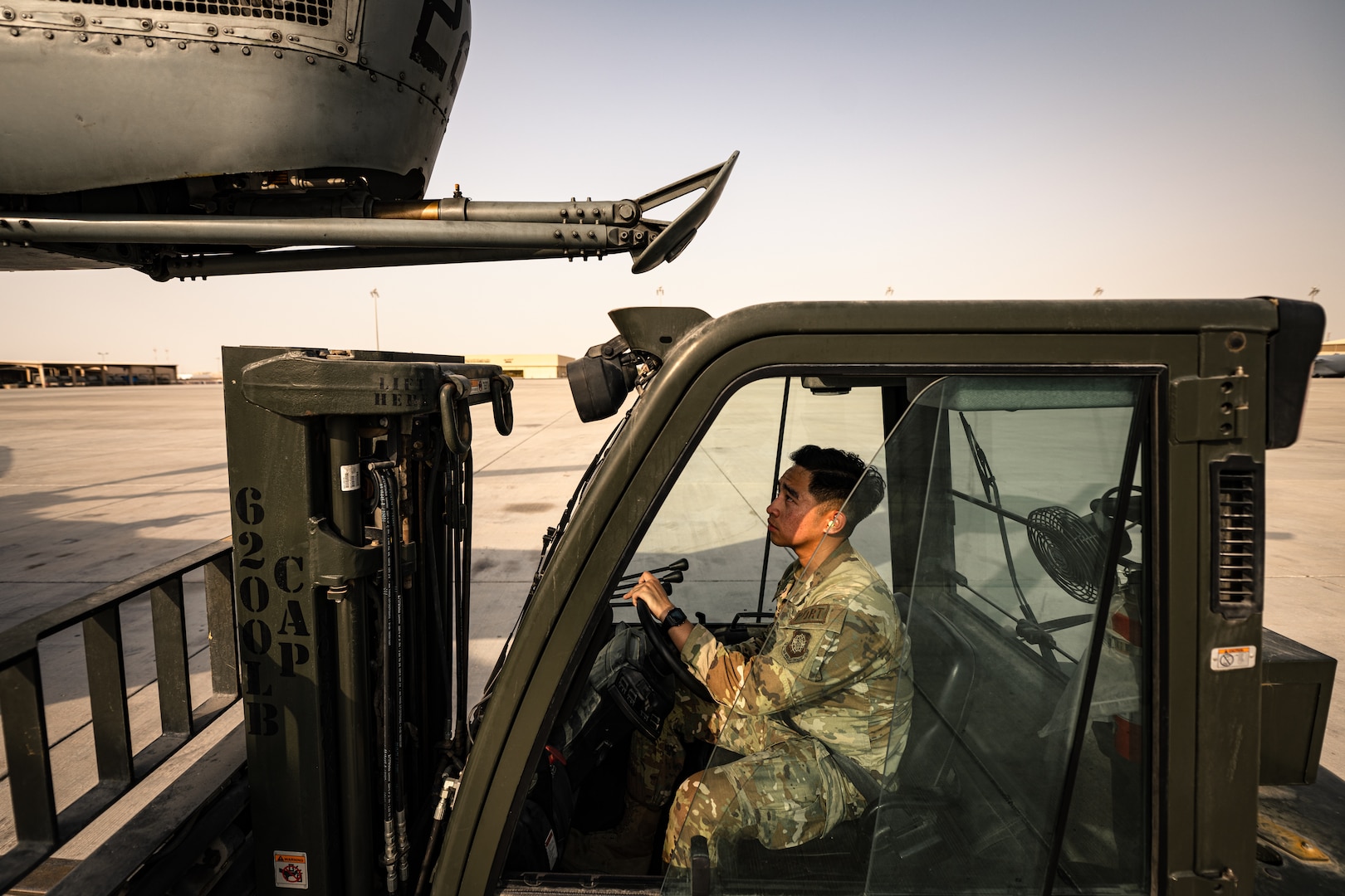 Photo of person loading cargo onto an aircraft