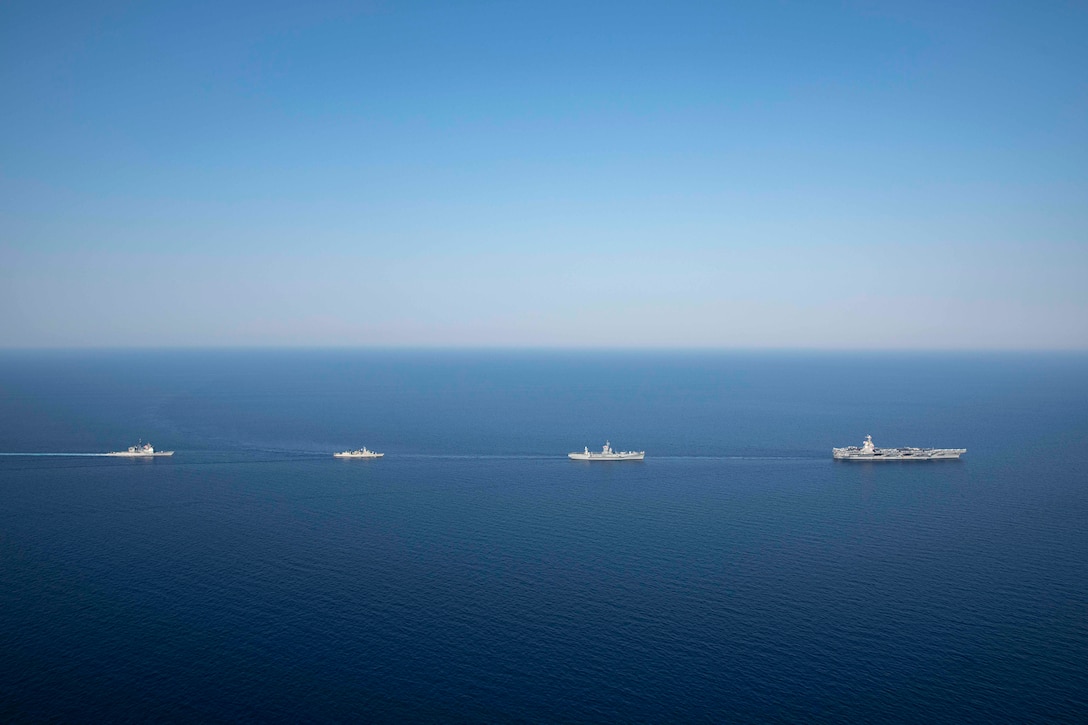 Four ships sail in a line.