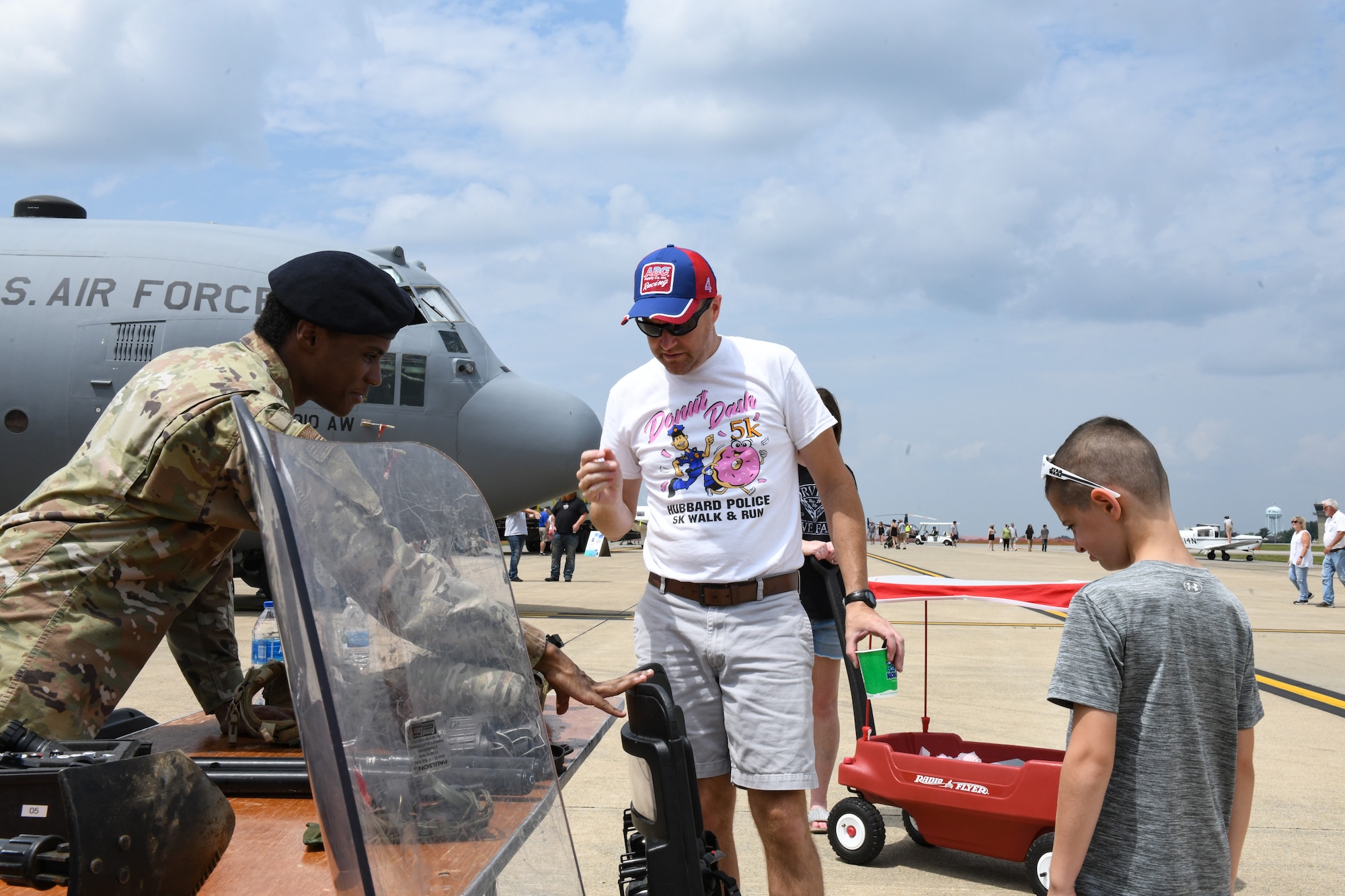 Senior Airman Justin Williams, a 910th Security Forces Squadron Airmen, talks with event guests, Aug. 6, 2023, at the Wings and Wheels Fly-In and Car Show at Youngstown-Warren Regional Airport, Ohio.