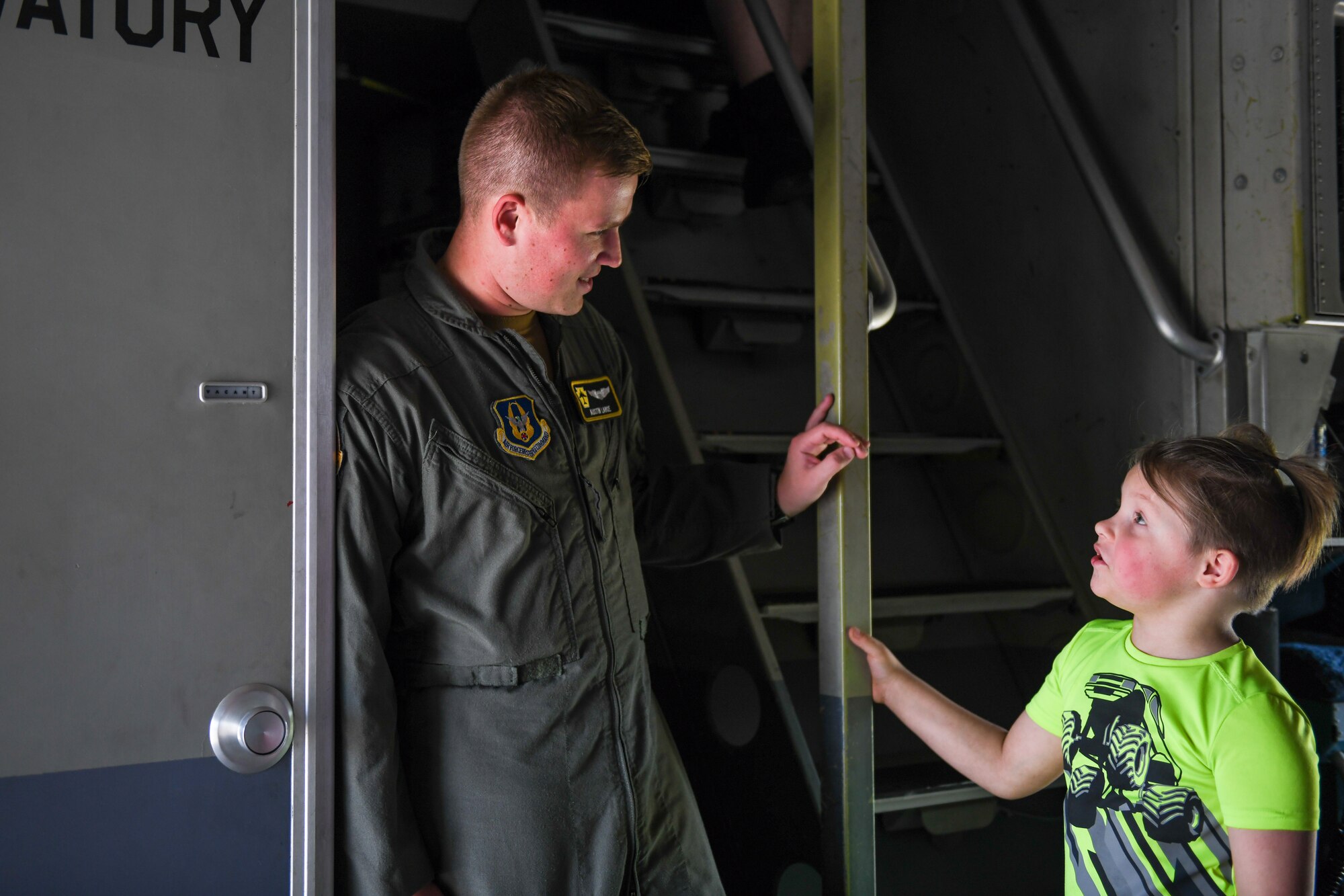 First Lt. Austin Large, a pilot assigned to the 758th Airlift Squadron at Pittsburgh Air Reserve Station, Pennsylvania, talks with event guest inside of a C-17 Globemaster III aircraft on the flightline, Aug. 6, 2023, at the Wings and Wheels Fly-In and Car Show at Youngstown-Warren Regional Airport, Ohio.