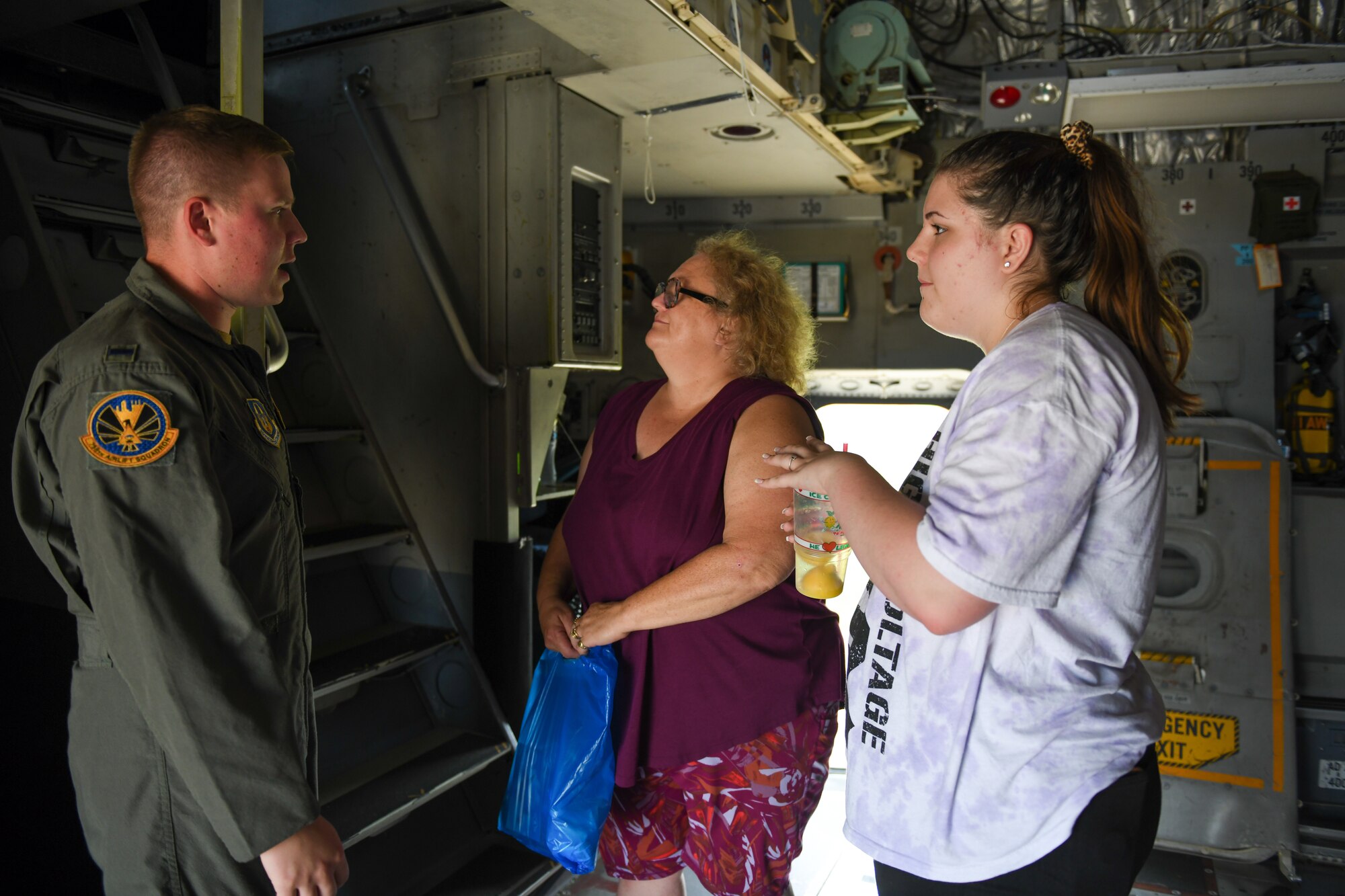 First Lt. Austin Large, a pilot assigned to the 758th Airlift Squadron at Pittsburgh Air Reserve Station, Pennsylvania, talks with event guests inside of a C-17 Globemaster III aircraft, Aug. 6, 2023, at the Wings and Wheels Fly-In and Car Show at Youngstown-Warren Regional Airport, Ohio.