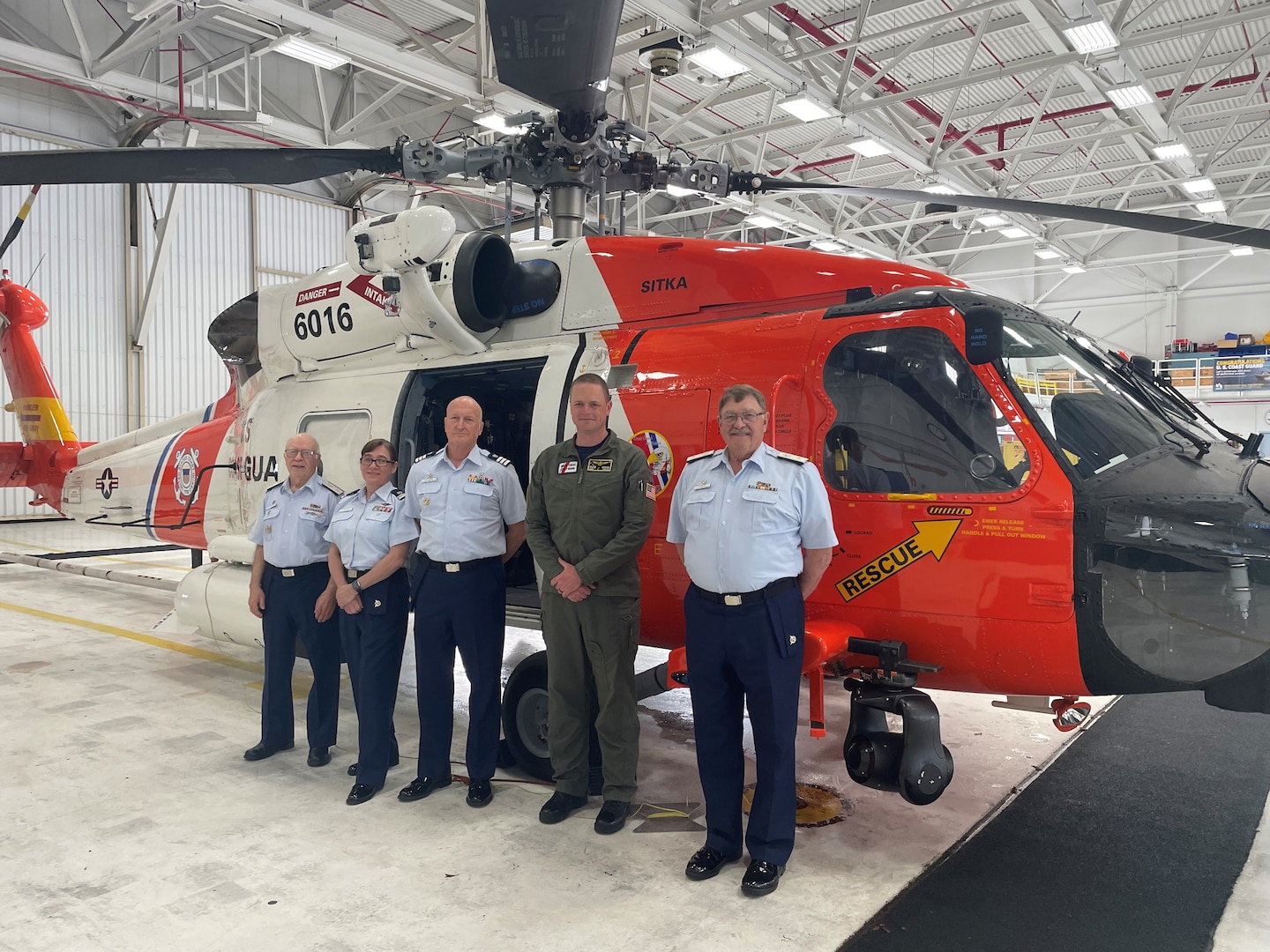 Auxiliarist Chester “Chet” L. Williams (center) at Coast Guard Air Station Sitka on his tour of Southeast Alaska, with the mission of growing the Auxiliary and help further support active-duty personnel. U.S. Coast Guard photo, courtesy Lt. Cmdr. Christopher Schleck